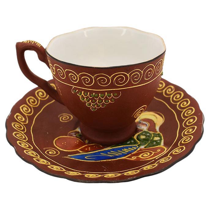 Moriage Figural Porcelain Teacup and Saucer in in Maroon and Gold, Japan For Sale