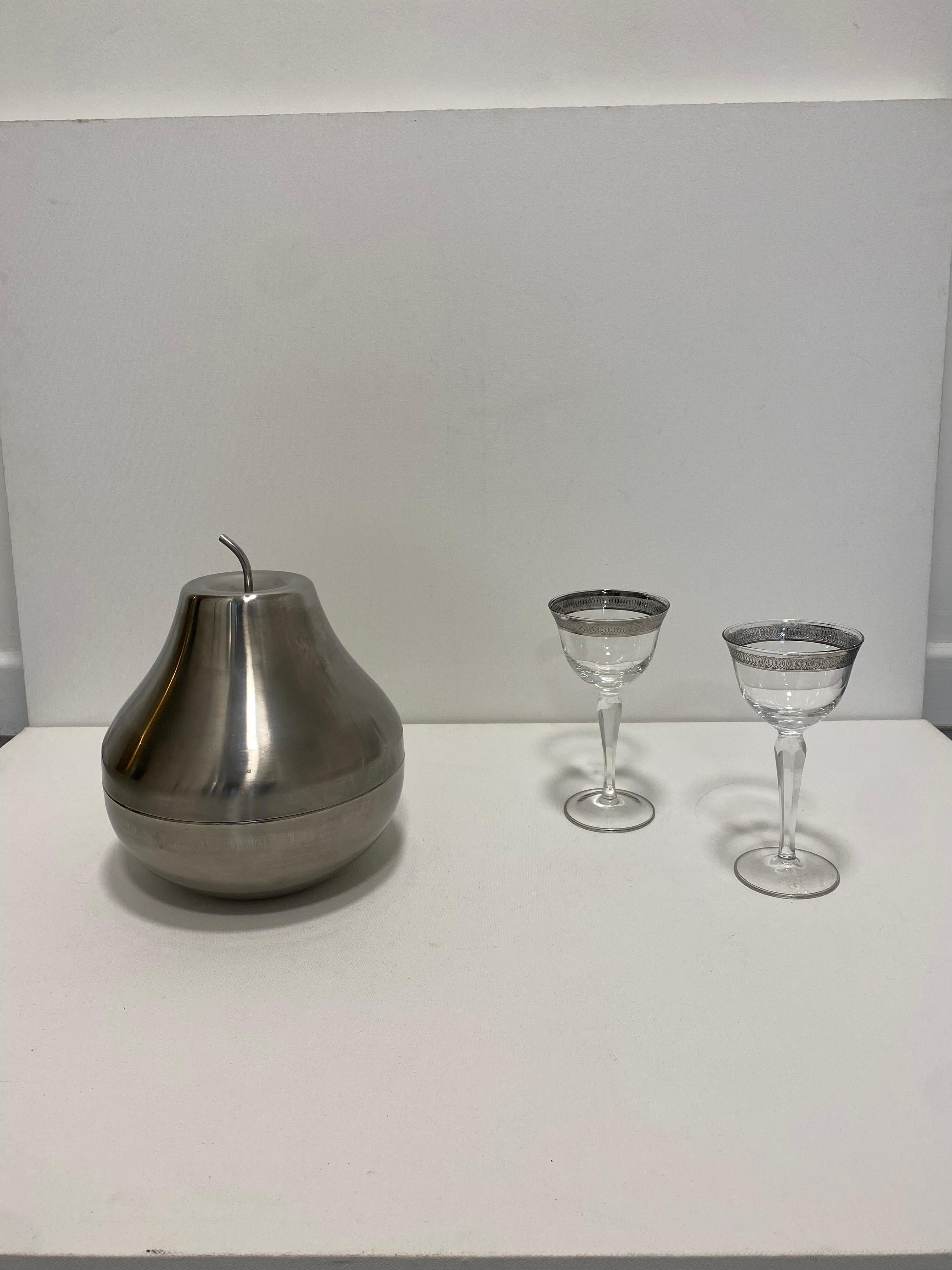 Graceful large italian pear-shaped brushed stainless steel ice bucket.

The ice bucket is made of aluminium steel and brushed brass outer finish with a smooth, gently aged patina, giving it a warm golden hue. The body has a minimalist shape that