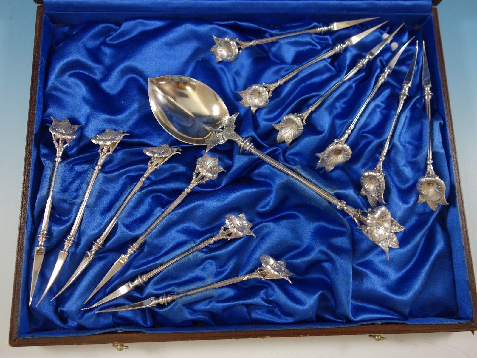 Fabulous morning glory by Gorham sterling silver nut set of 13 pieces. This superb figural pattern features a 3-D morning glory flower at the end of the handle, in realistic detail. This set includes:

12 nut picks 4 3/4