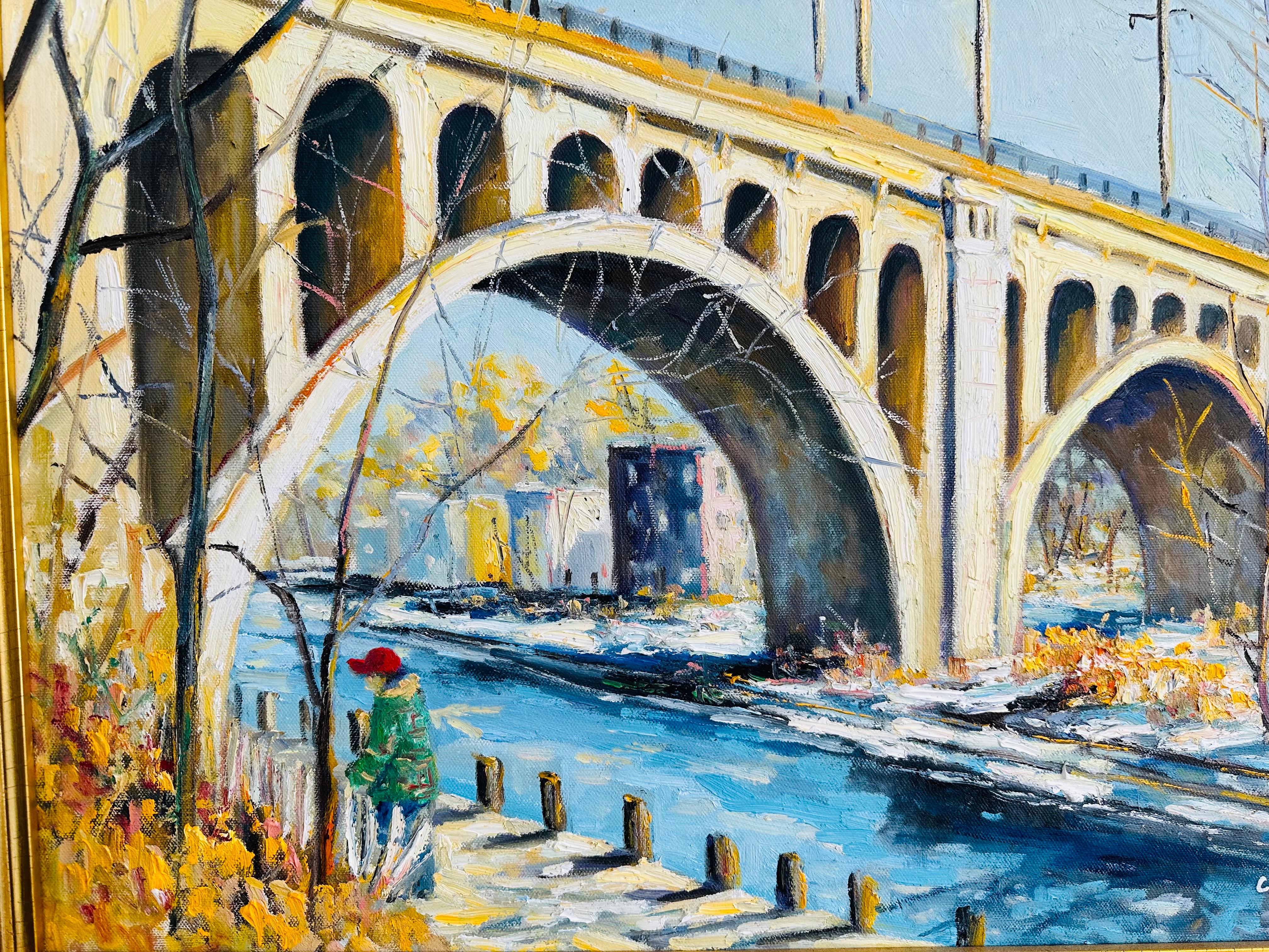 Philadelphie impressionniste - Promenade matinale sous le pont de Manayunk. Un homme bien emmitouflé se promène le long du sentier du canal. Un pont historique de Philadelphie tombe en cascade sur la toile de fond par une froide journée d'hiver. Le