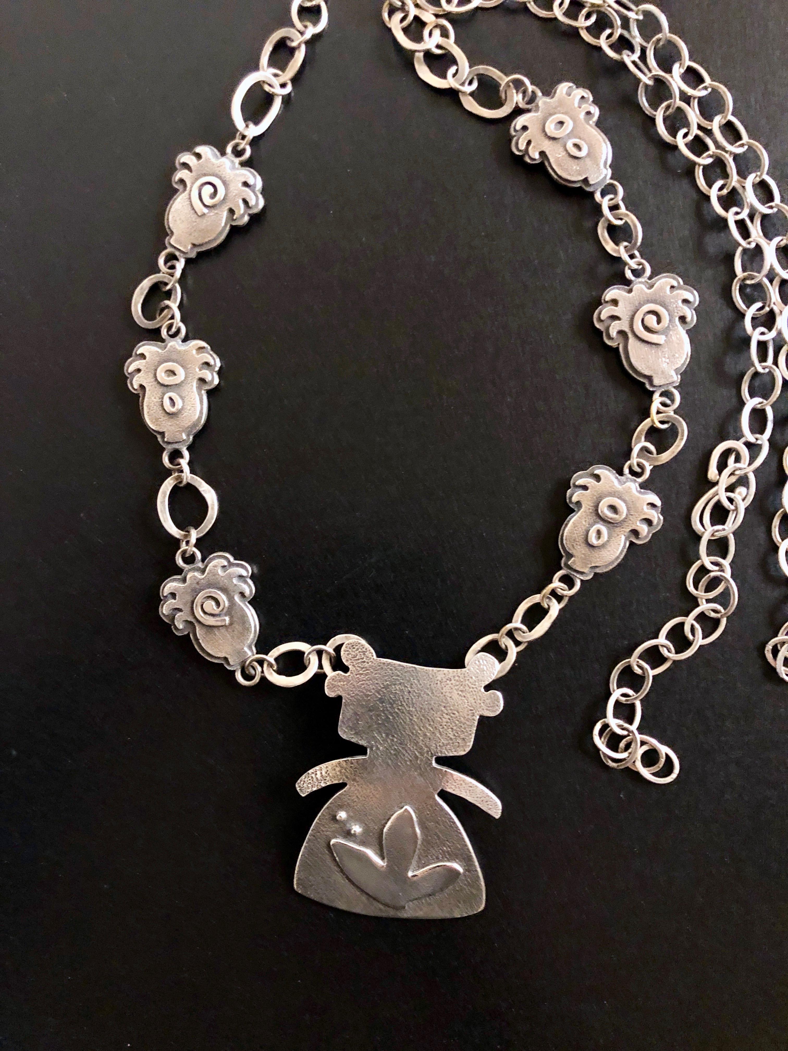 Morning Walker, cast sterling silver link necklace, Hopi woman, plants, circles, adjustable length
Morning Walker, by Melanie Yazzie, silver necklace, Hopi woman, plants, circles
Melanie A. Yazzie (Navajo-Diné) is a highly regarded multimedia artist