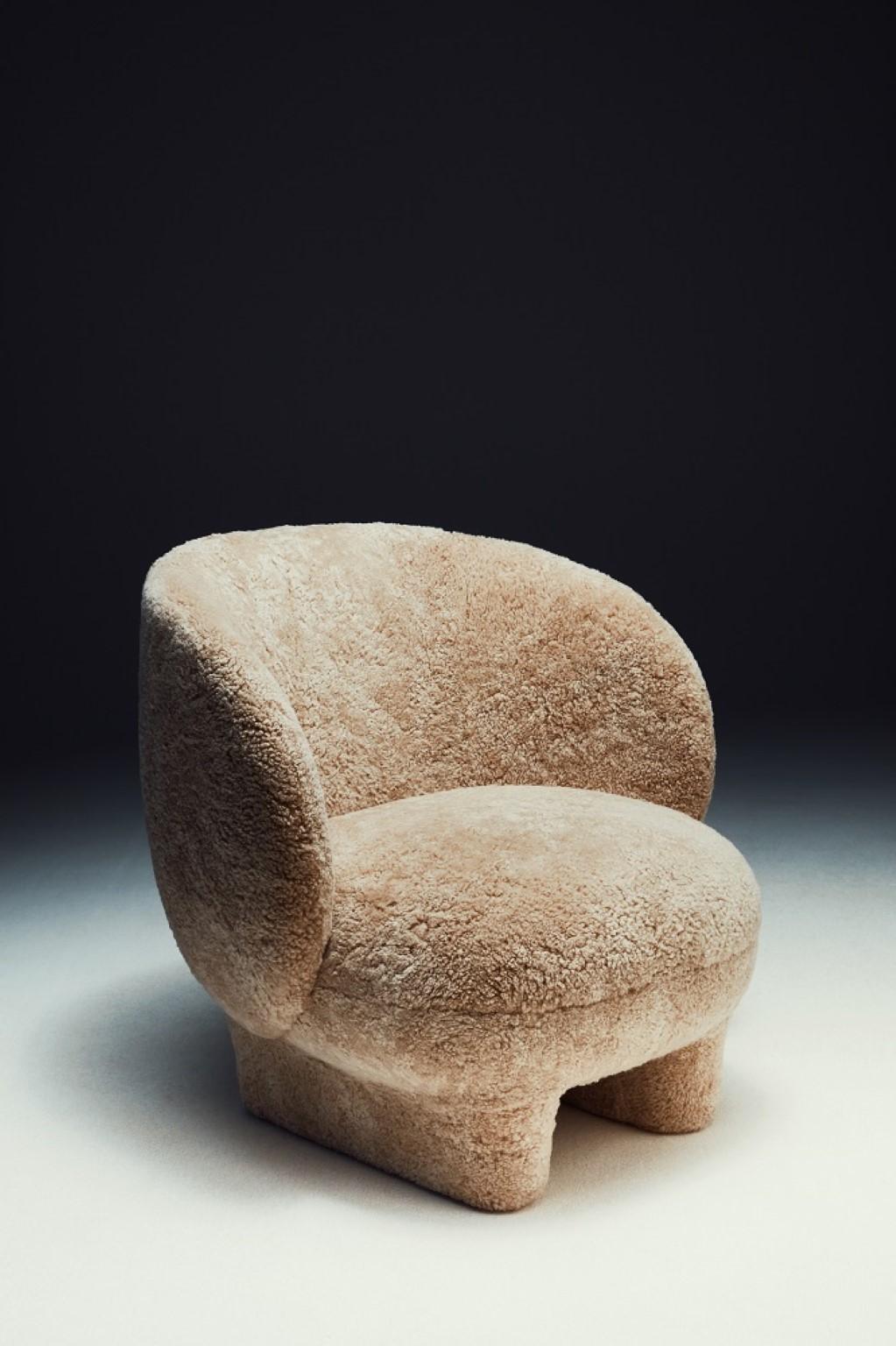 Moro Armchair by Sebastian Herkner
Dimensions: D 80 x W 80 x H 78.5 cm 
Materials: Sheepskin
Available in different fabrics.

‘Moro’ is a cosy cocoon of a chair. Named after a famous Venetian Doge, the design evokes the strong personality of an