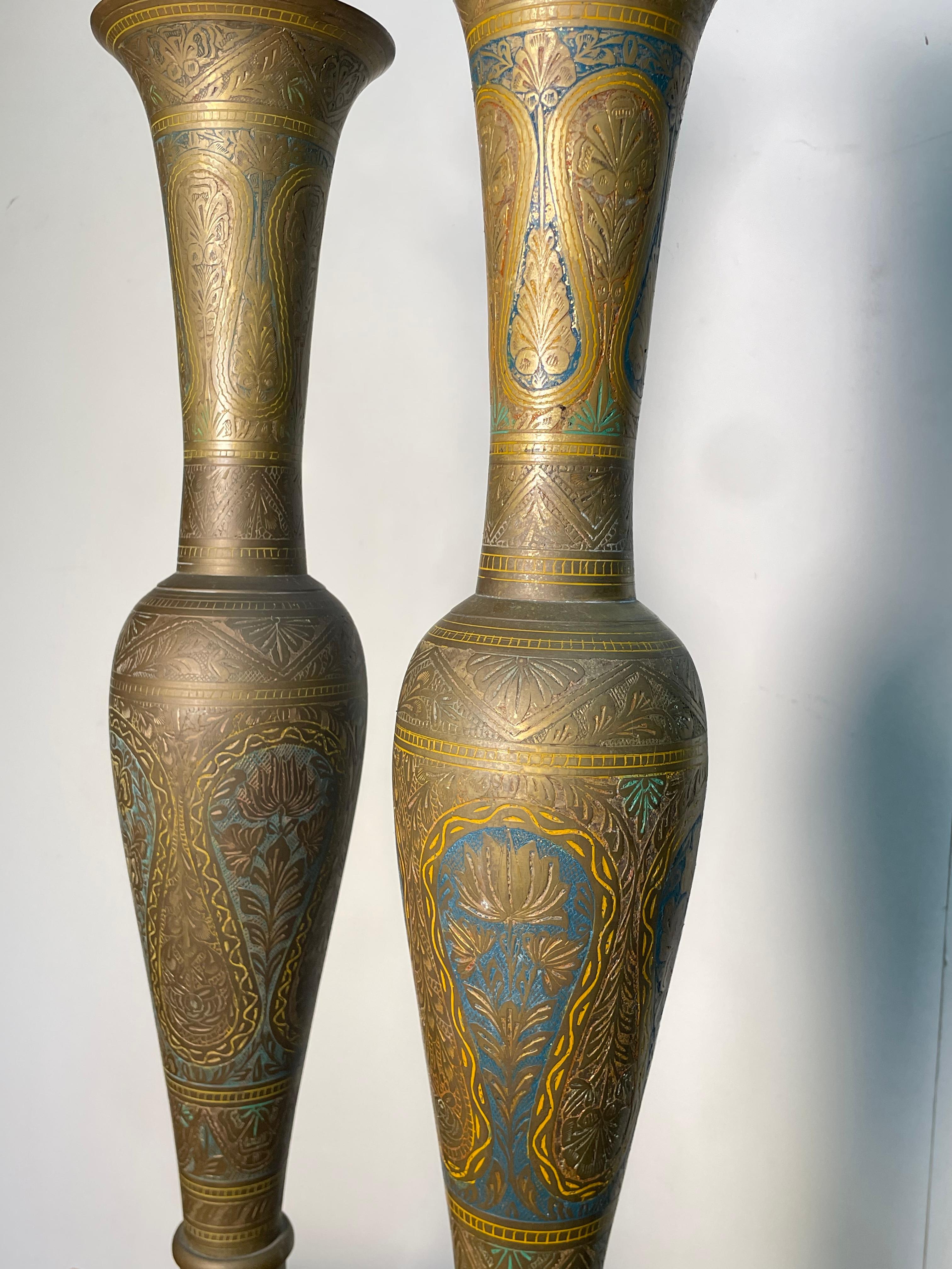 Moroccan 2 Piece Brass Irons made in the 19th Century with beautiful embellishments of teal, yellow, blue, and red. The colors have faded over the centuries, but it still has immaculate beauty and saturation to it. The pieces really speak for