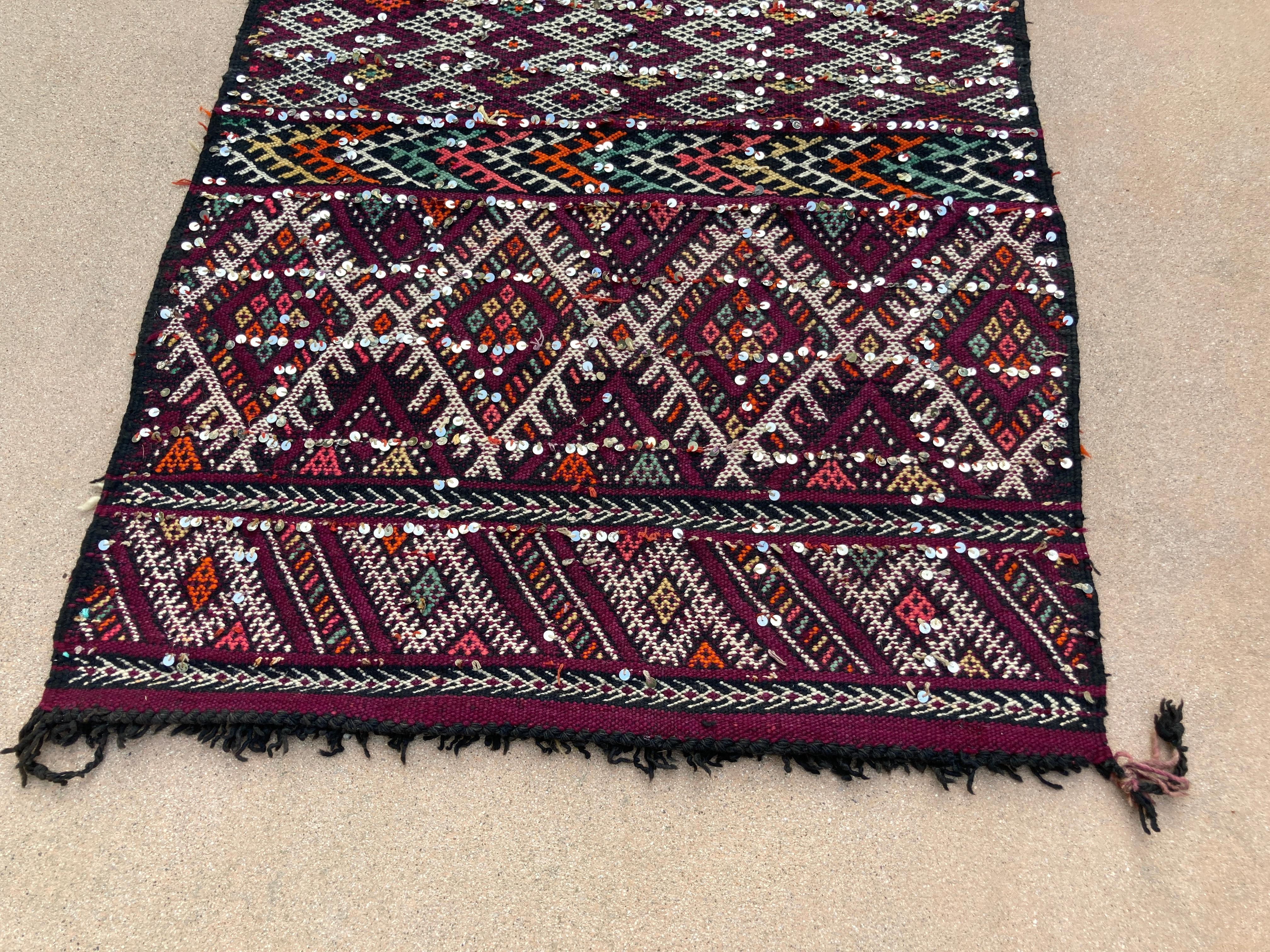 1940s Moroccan Tribal Rug African  Ethnic Textile Floor Covering.
Vintage semi antique, Moroccan tribal rug, nomadic African Tuareg rug, wool and cotton embroidered geometrical modernist designs and adorned with sequins.
22 ft Moroccan runner ethnic