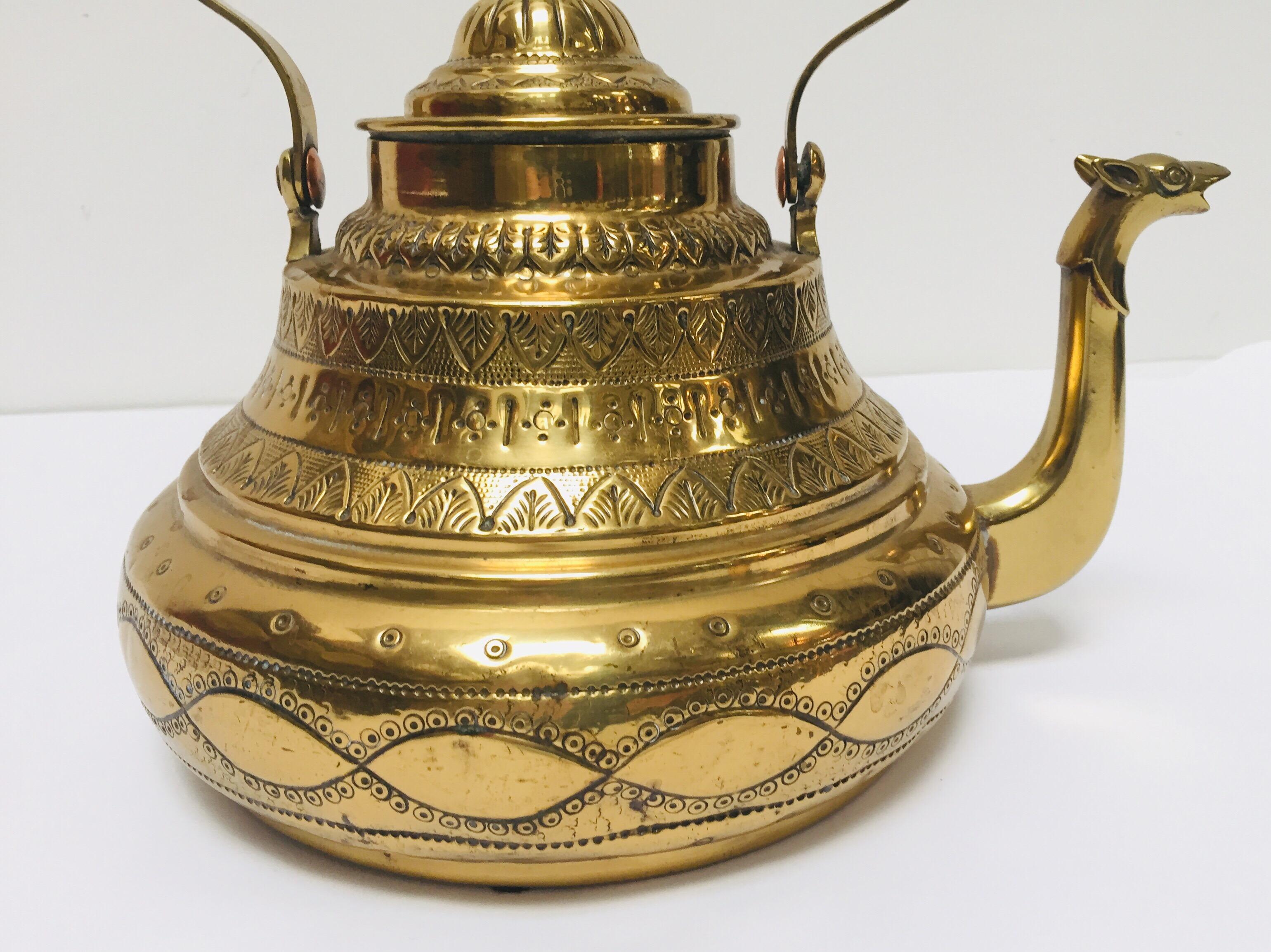 Moroccan antique brass tea kettle pot with camel head spout
Museum quality, one of a kind antique artistically and delicately handcrafted tea water pot.
Camel shape water kettle in solid brass, hand-hammered, chased, engraved with floral and