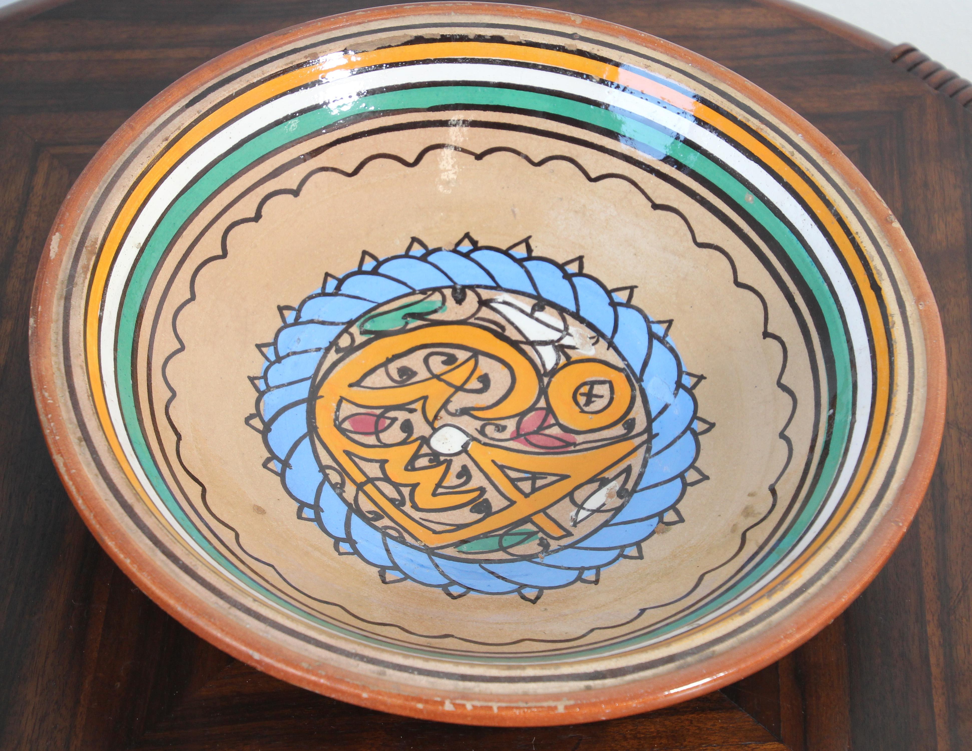 Moroccan under-glazed painted pottery bowl, rising on a low foot.
The interior is hand painted with polychrome abstract and Arabic calligraphy design in blue, orange and brown with turquoise accents.
Handcrafted in Morocco by artisan.
Antique 19th