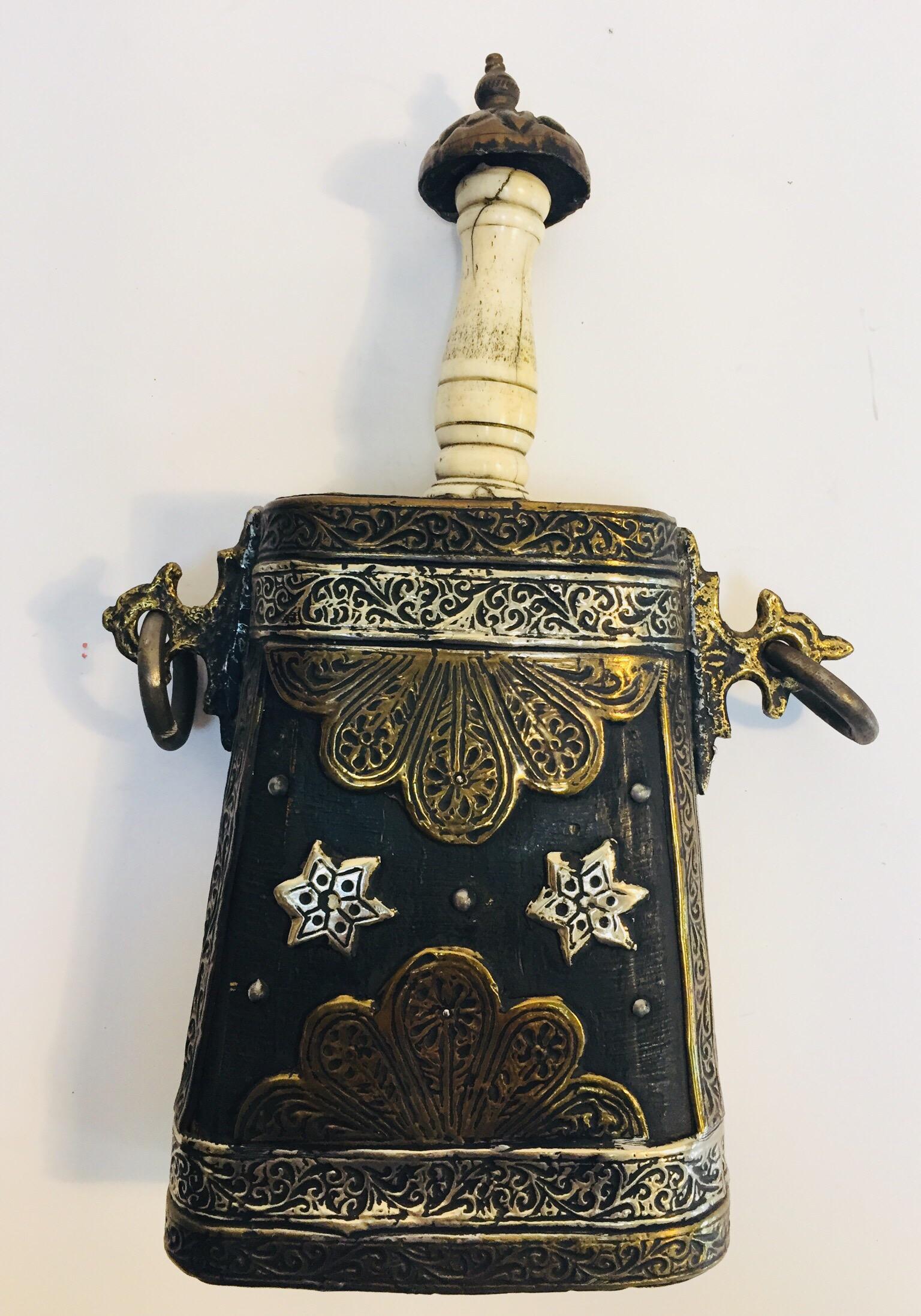Hand made early 20th century Moroccan antique Berber case flask, carved wood covered with brass and silvered metal filigree, delicately hand-hammered metal with animals decor for power protection, the top straight neck spout is made out of carved