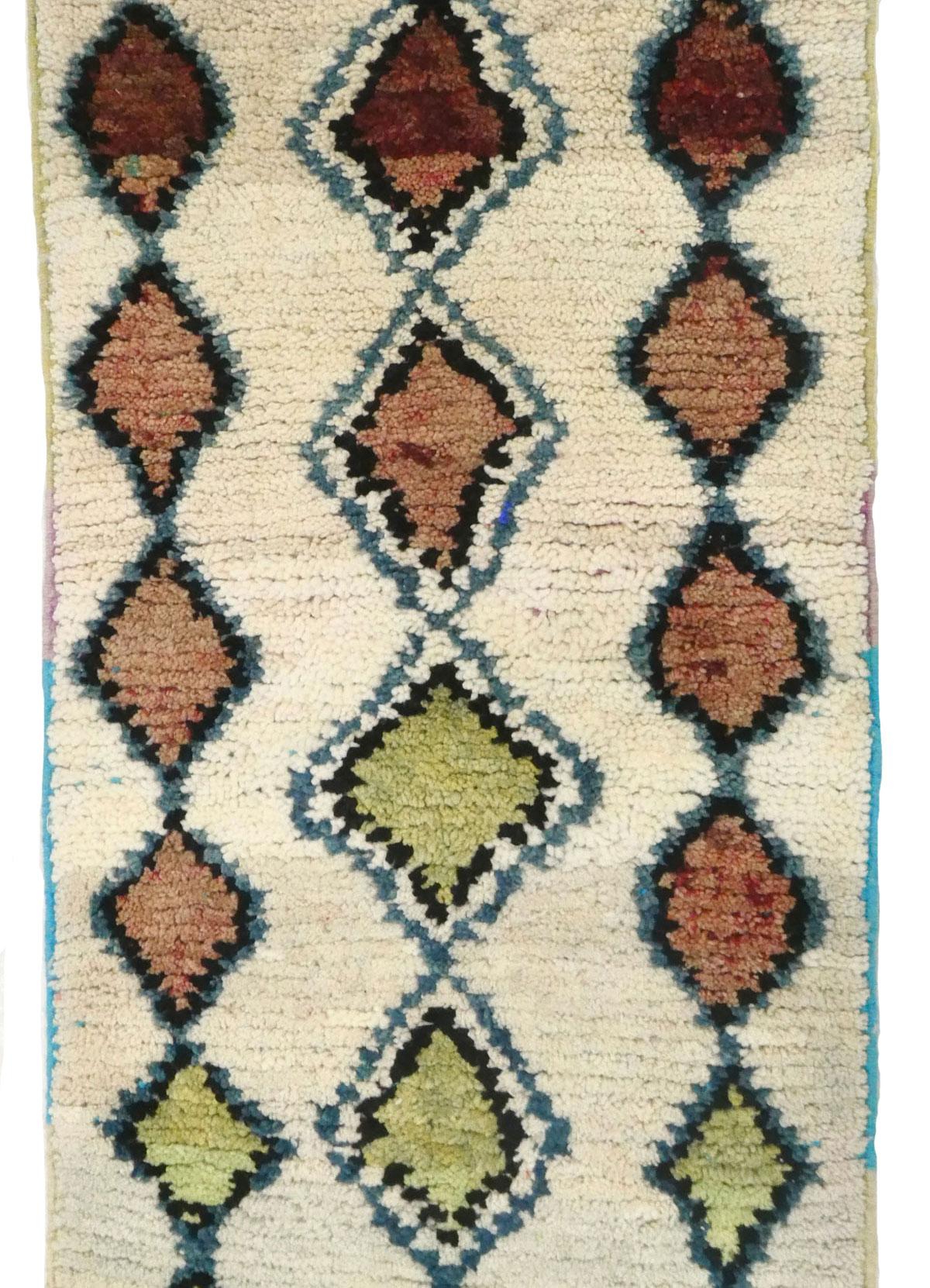 Vintage Moroccan runner hand woven in brown, blue, green and ivory wool in an abstract  Berber pattern.   Dimensions: 2’7 x 10’1
 Azilal rugs emerged from Morocco's high Atlas mountains around the 16th century  with a distinct tradition of women