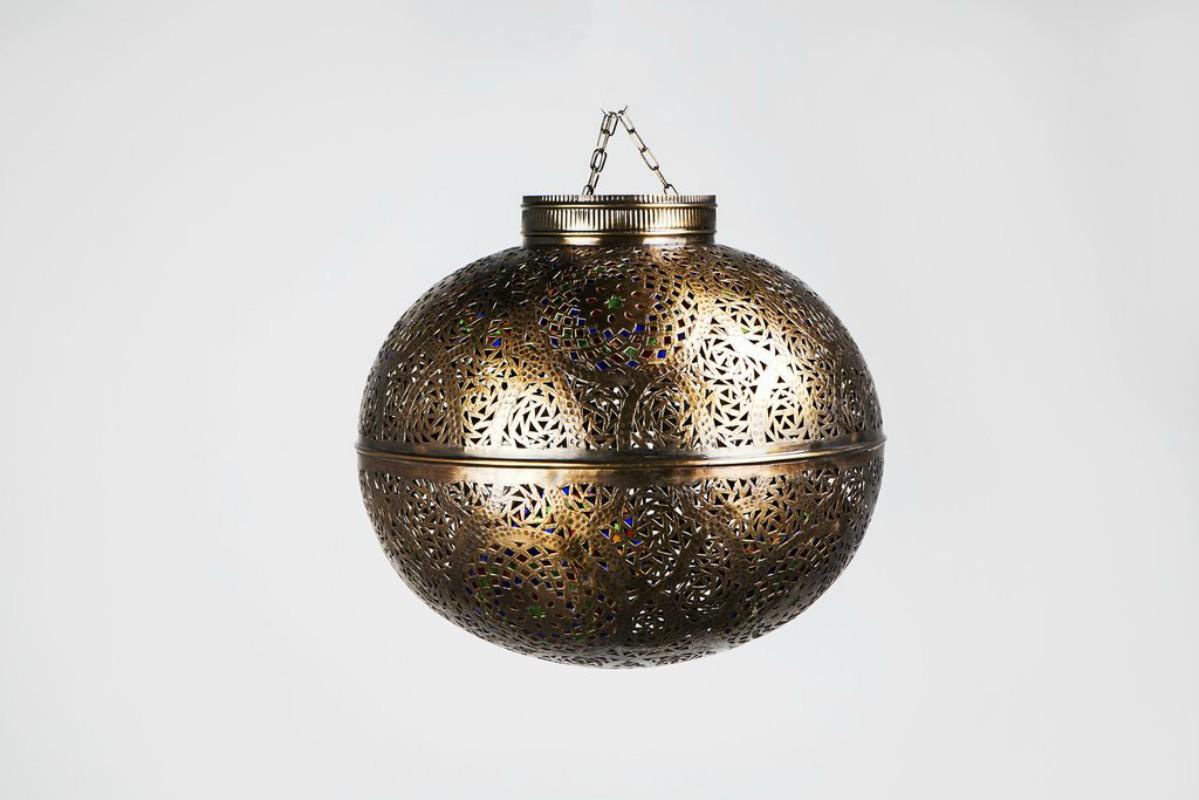 Come marvel at the intricate and highly ornamental design work of this handcrafted dark copper round-shaped lamp. With multicolored glass panes and a festive ball-shaped design, this light-emitting orb adds an exotic aesthetic to any living space.