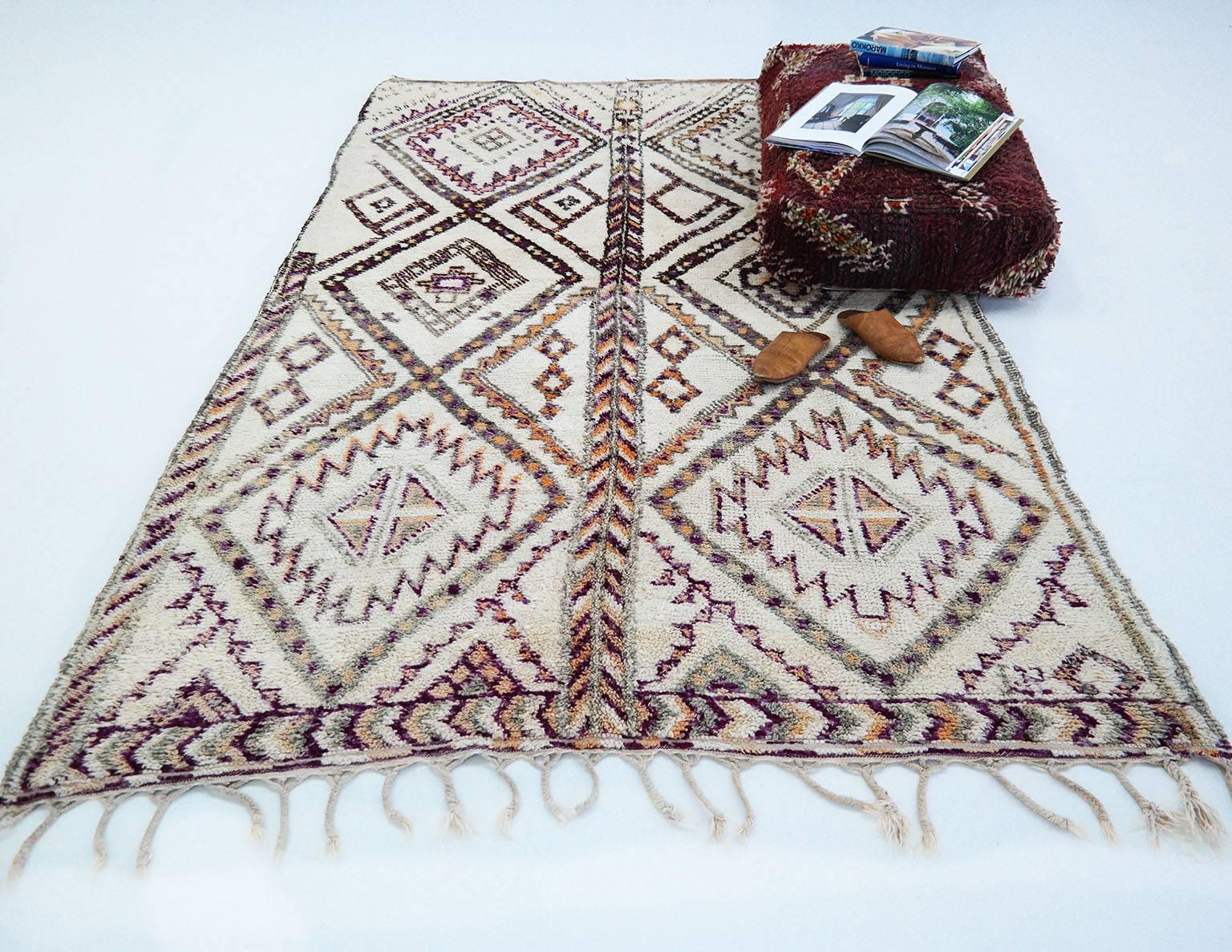 Beni Ourain rug

As stunning vintage Moroccan rug in great condition. This beauty has a pattern with beautiful color accent and a warm butter cream base. The shades of orange and aubergine purple are naturel dye. 
Beni Ourain rugs have a story to