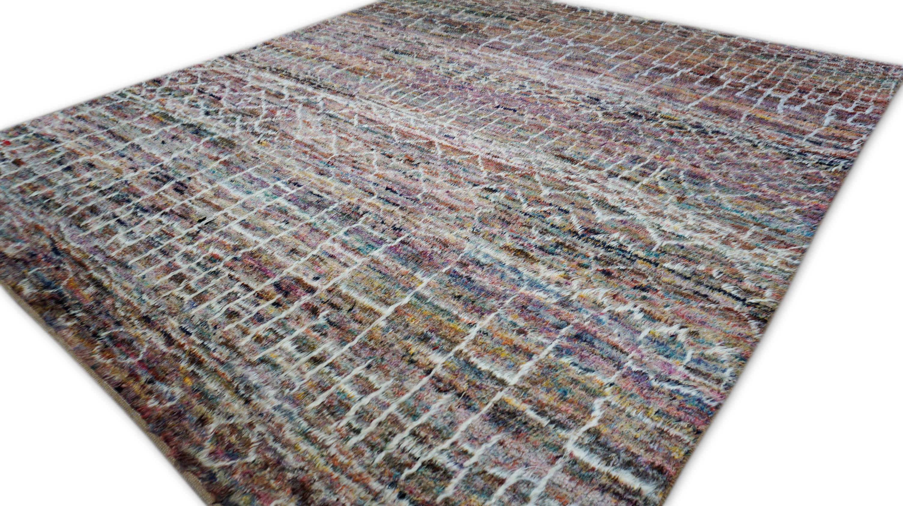 This richly textured hand-knotted wool rug is a vibrant contemporary take on tribal design traditions. Woven with hand-spun wool, it belongs to the modern tribal or Berber-inspired rug category, featuring irregular white linear motifs drawn from