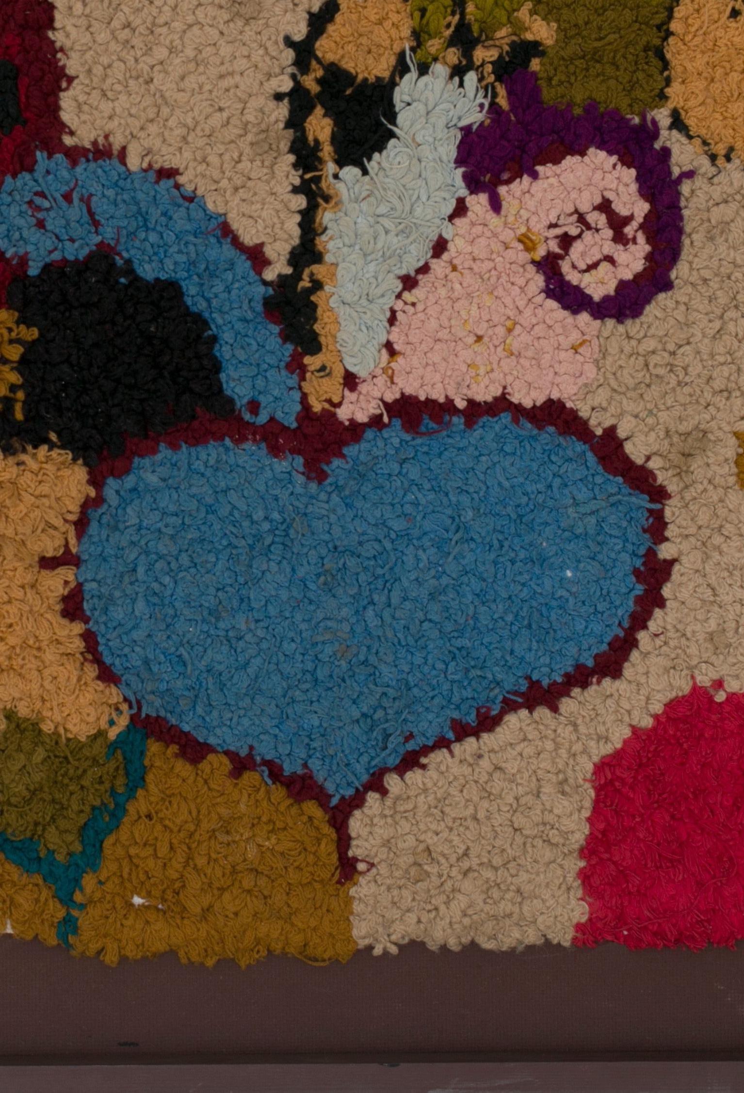 Protection and love, hand and heart both common symbolic representations
This tapestry was made by Berber women from the Atlas Mountains.
Made from woollen ends and other threads, embroidered on wasted plastic bags of cereals, this unique and