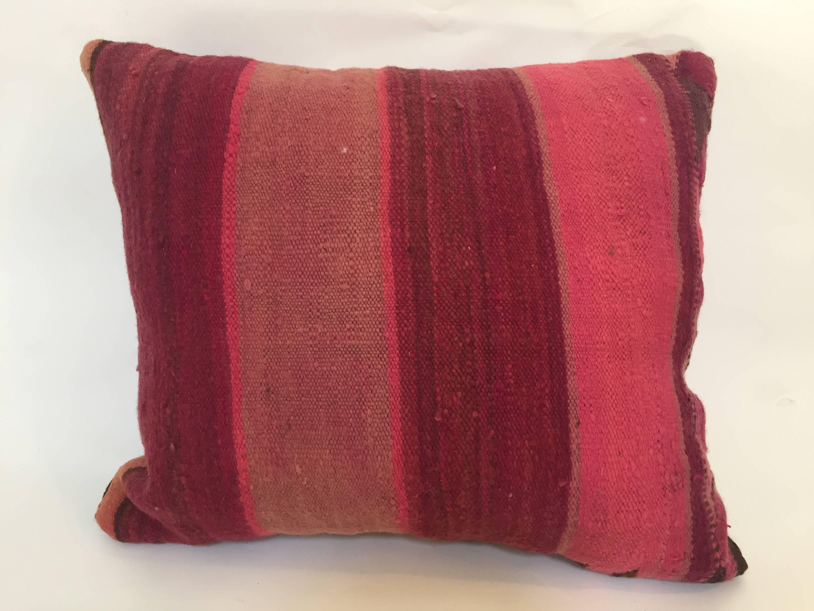 Custom Berber pillow cut from a vintage hand woven wool Moroccan tribal flat-weave Kilim tribal rug.
Handwoven by the Berber women from the Atlas Mountains of Morocco. 
Great handcrafted textile with earth tone colors large stripes in purple,