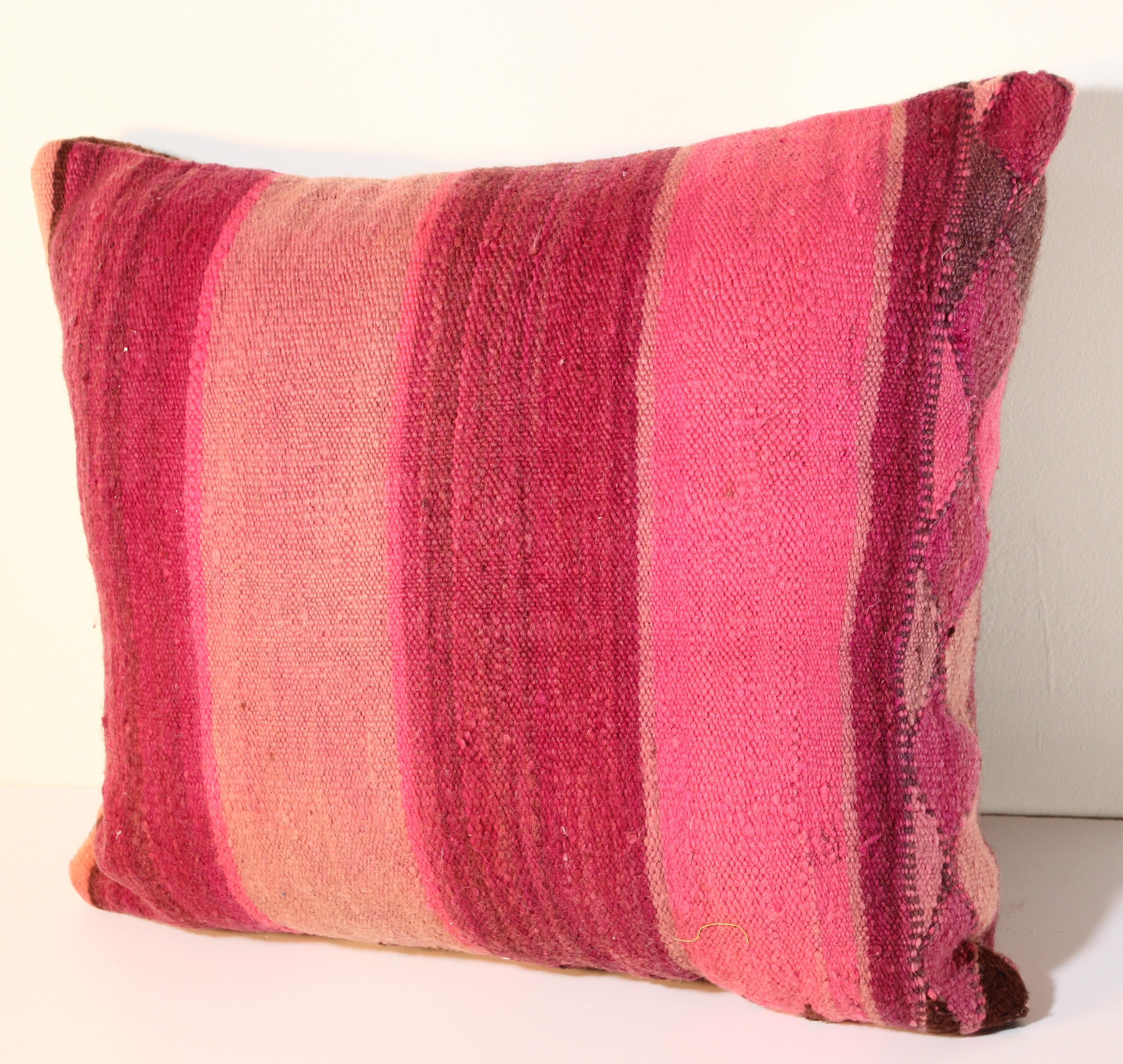 Custom Berber lumbar pillow cut from a vintage hand woven wool Moroccan tribal flat-weave Kilim tribal rug.
Handwoven by the Berber women from the Atlas Mountains of Morocco.
Great handcrafted textile with earth tone colors large stripes in purple,