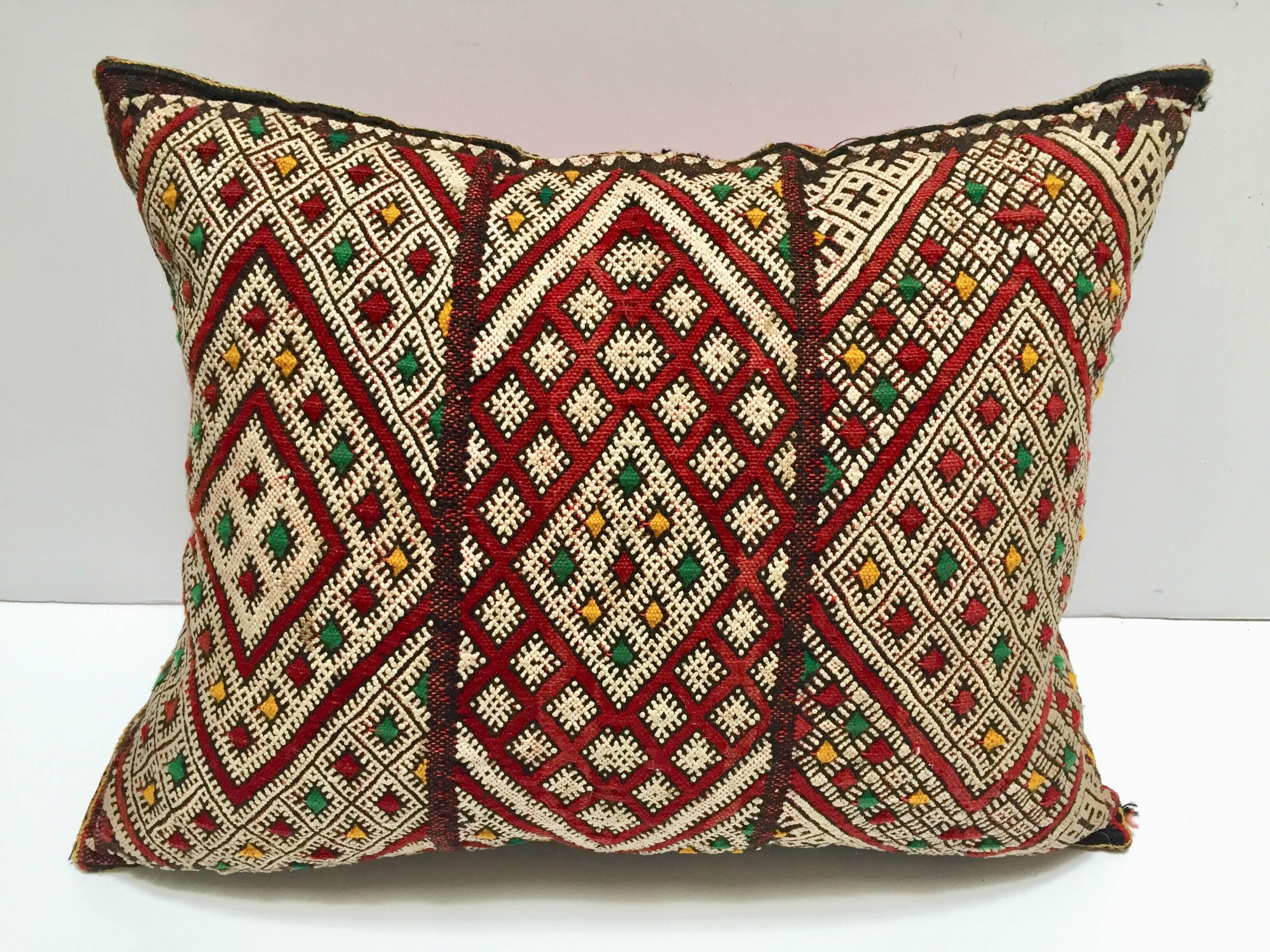 Moroccan Berber pillow with geometric tribal African designs.
Handwoven tribal throw pillow made from a vintage flat-weave rug.
The front and the back are made from a different rug, front is more elaborate and back is burnt orange.
Handwoven by