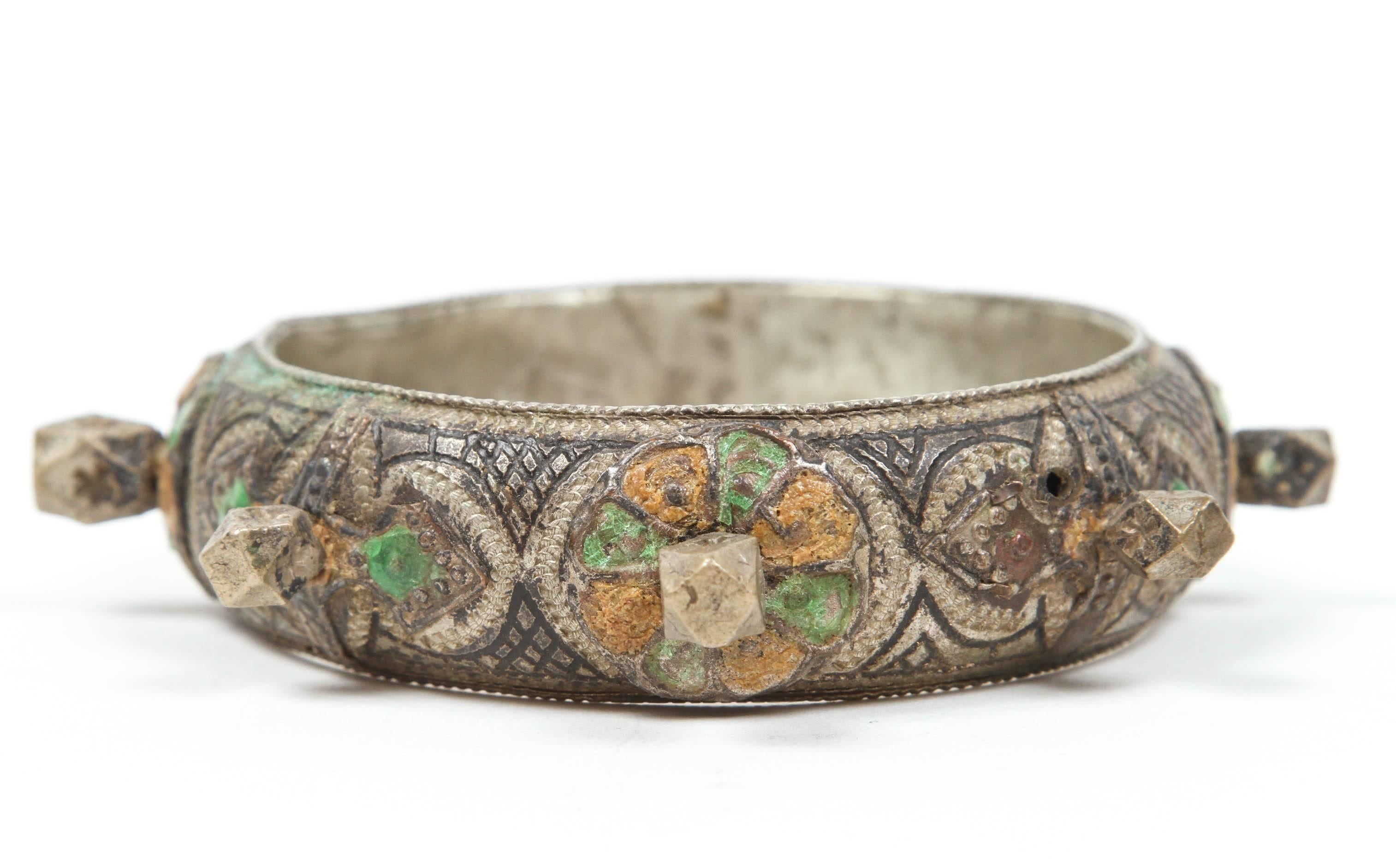 A 1920s handcrafted Ethnic bracelet by Berber women of Morocco.
Women wear this kind of bracelet and silver jewelry for special ceremonies and wedding. 
Silver, but not of the standard of sterling.
Richly embellished with applied silver spikes and