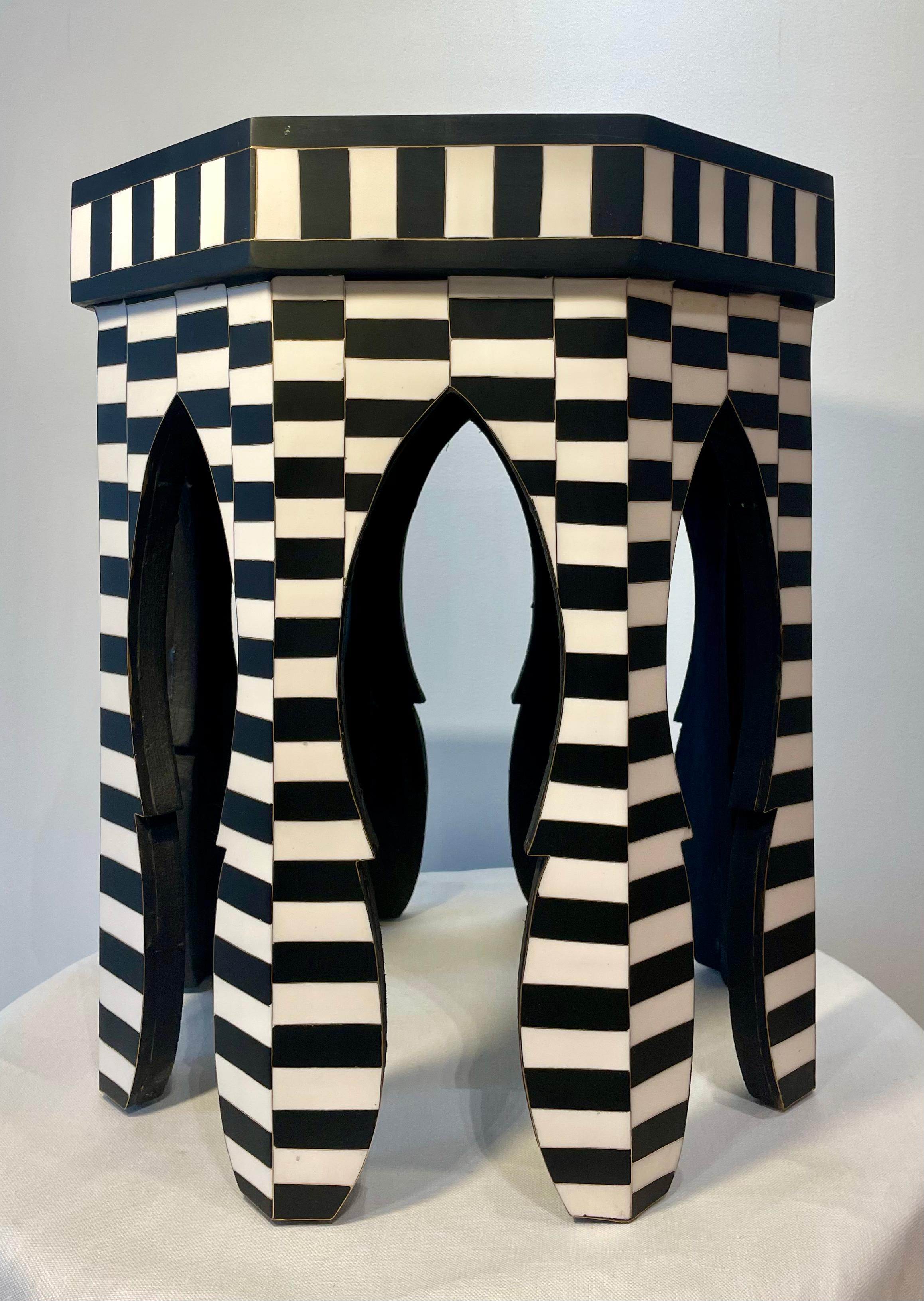 Moroccan side table made of natural dyes and camel bone. Designed in a geometric Moorish motif, the tables blend both exotic and modern flavors in a highly decorative way. 

