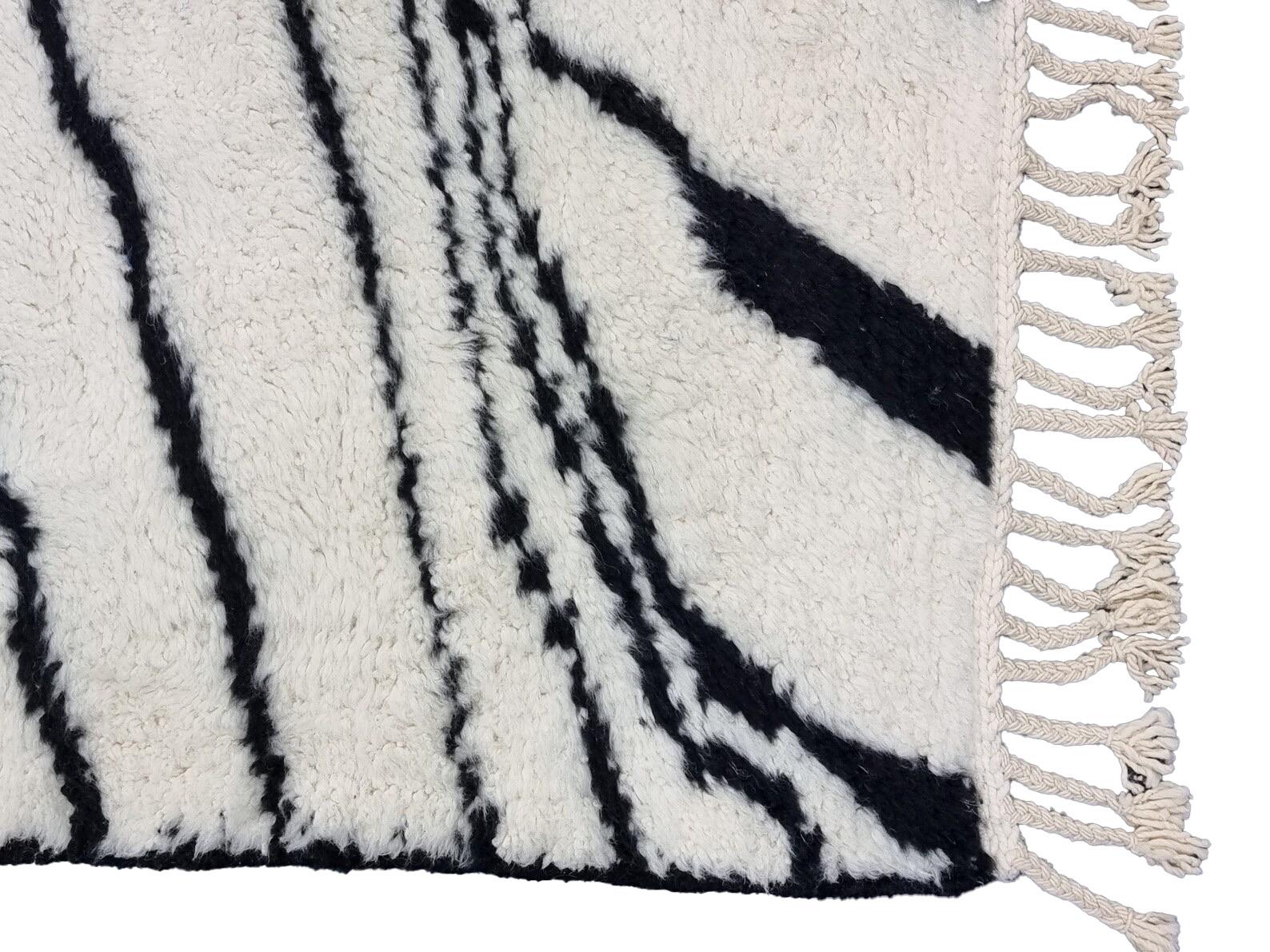 Moroccan Boujaad rug handwoven out of natural and soft sheep wool featuring black and white stripes.