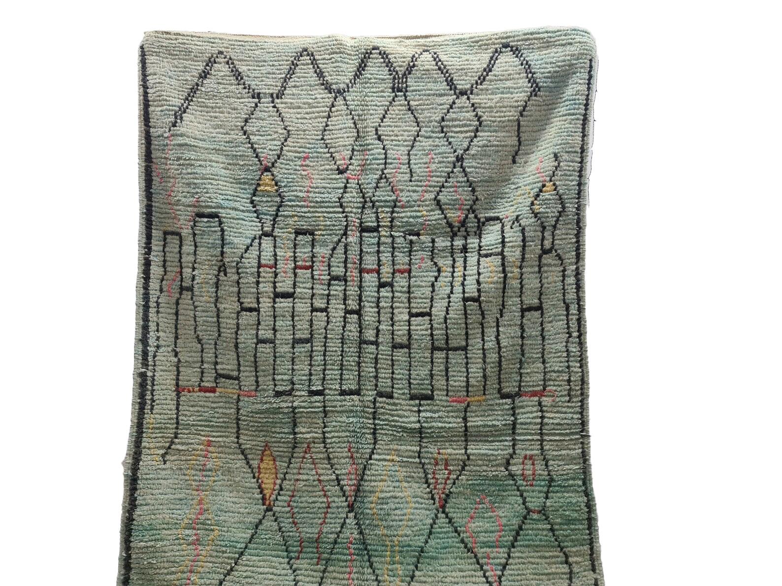 Moroccan Boujaad rug handwoven out of natural and soft sheep wool featuring faded blue background with abstract geometric lines.