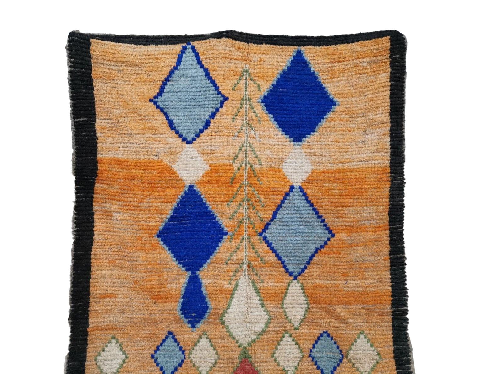 Moroccan Boujaad rug handwoven out of natural and soft sheep wool featuring orange background with blue geometric shapes. 
