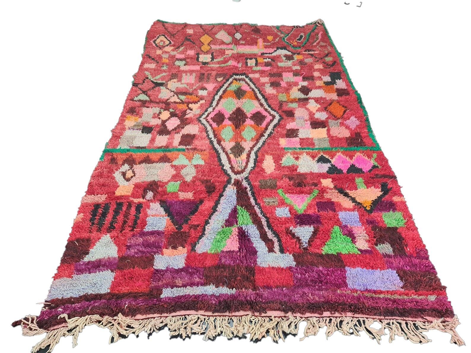 Moroccan Boujaad rug handwoven out of natural and soft sheep wool featuring red and multi colored abstract patterns. 