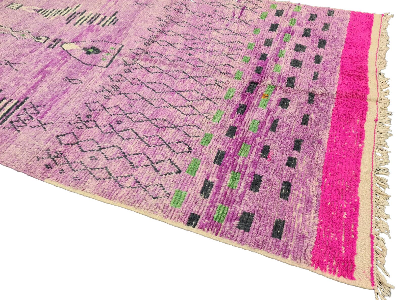 Moroccan Boujaad rug handwoven out of natural and soft sheep wool featuring bright red border and mauve background, along with geometric patterns blending Arabic and Berber cultures in Morocco. The colors are made from the natural dyes of flowers,