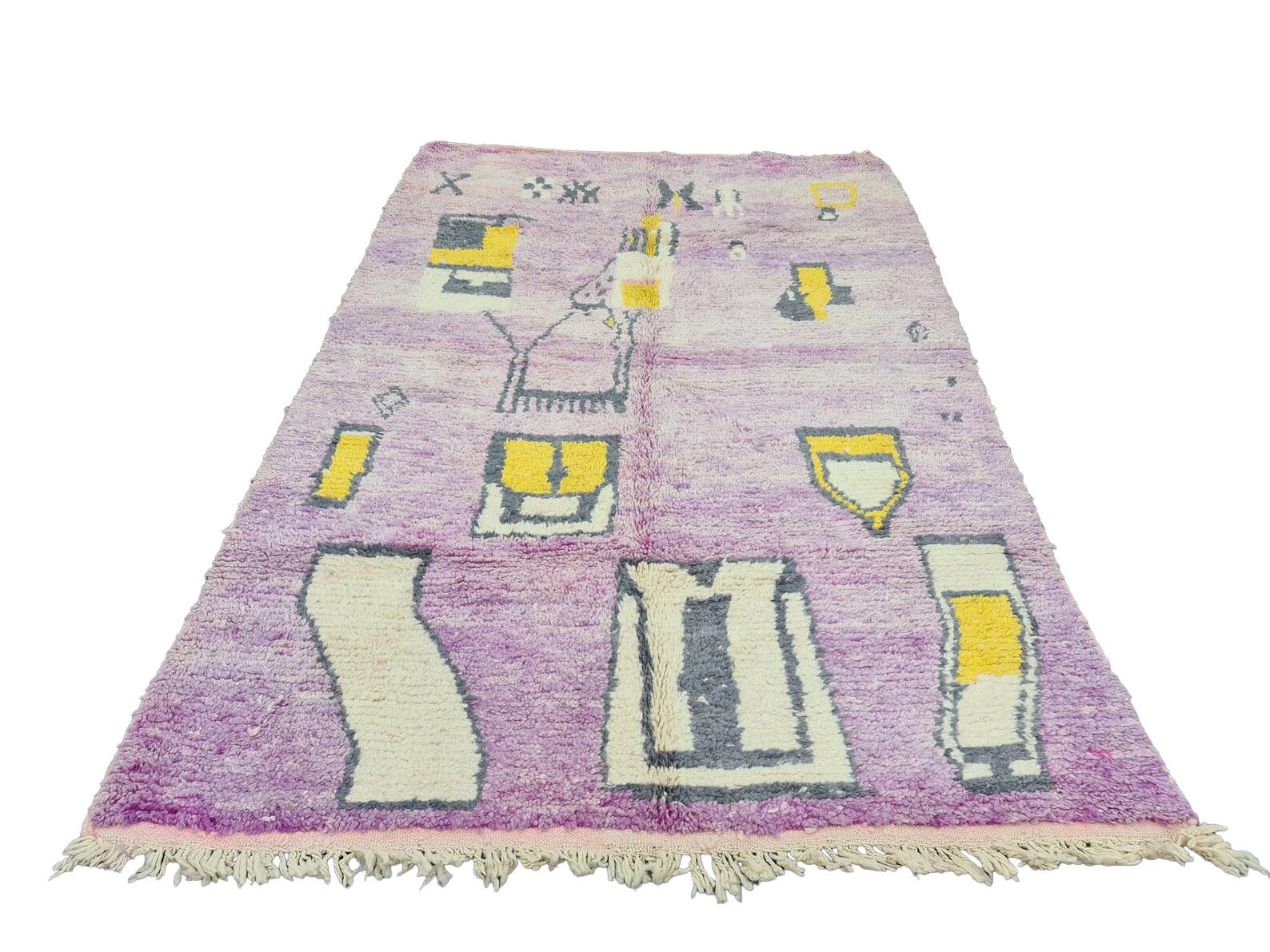 Moroccan Boujaad rug in faded purple with irregular yellow and black geometric patterns reflecting the artistic blend of Arabic and Berber cultures in Morocco. Every handmade rug is washed and dried in the mountain air and made with the finest