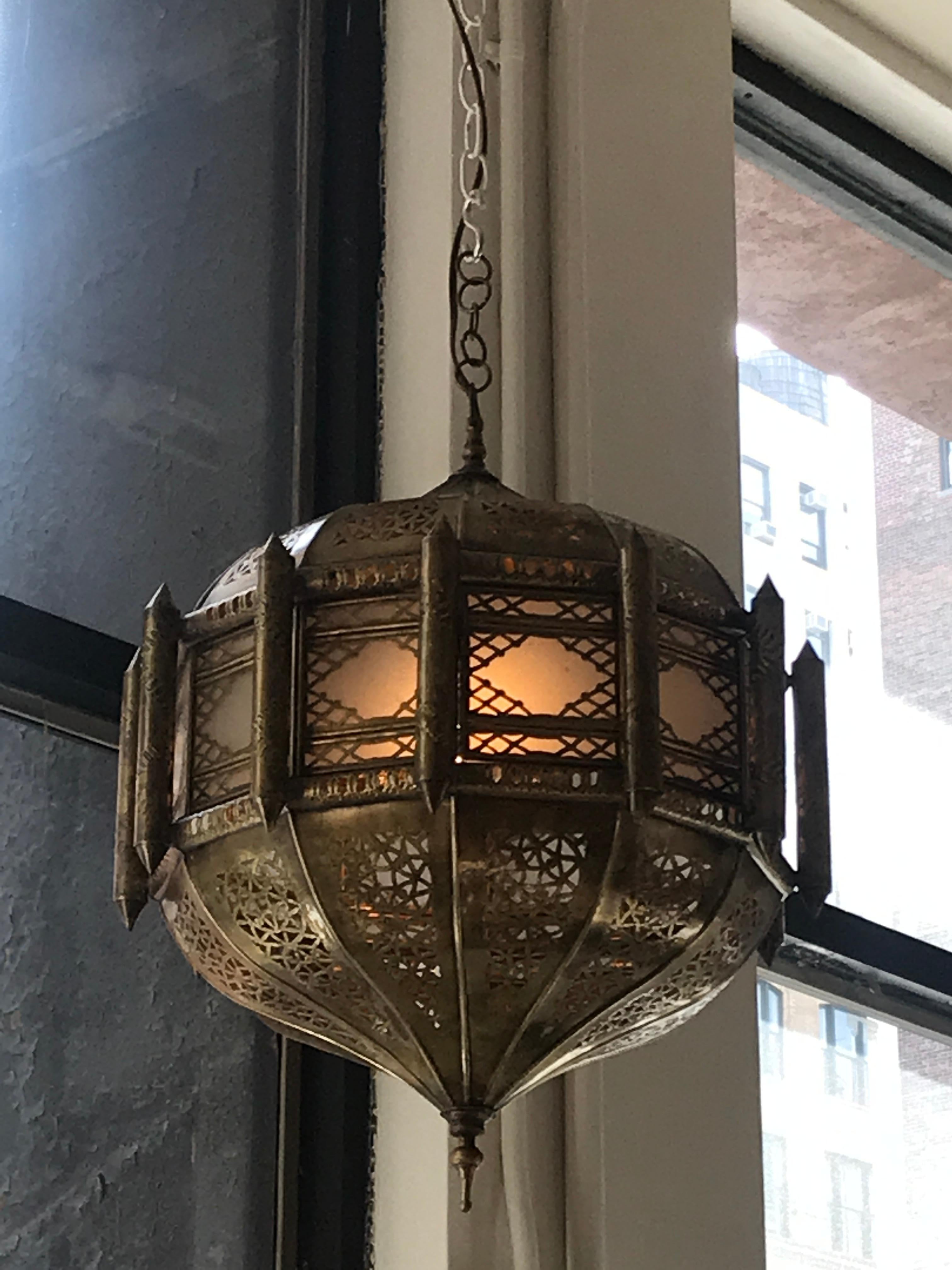 If you're looking to infuse your home, sanctuary, or summertime escape with a little Moroccan flare. This lantern piece features the intricate pattern work that defines the Moorish architecture and style of Northern Africa. The antique gold finish