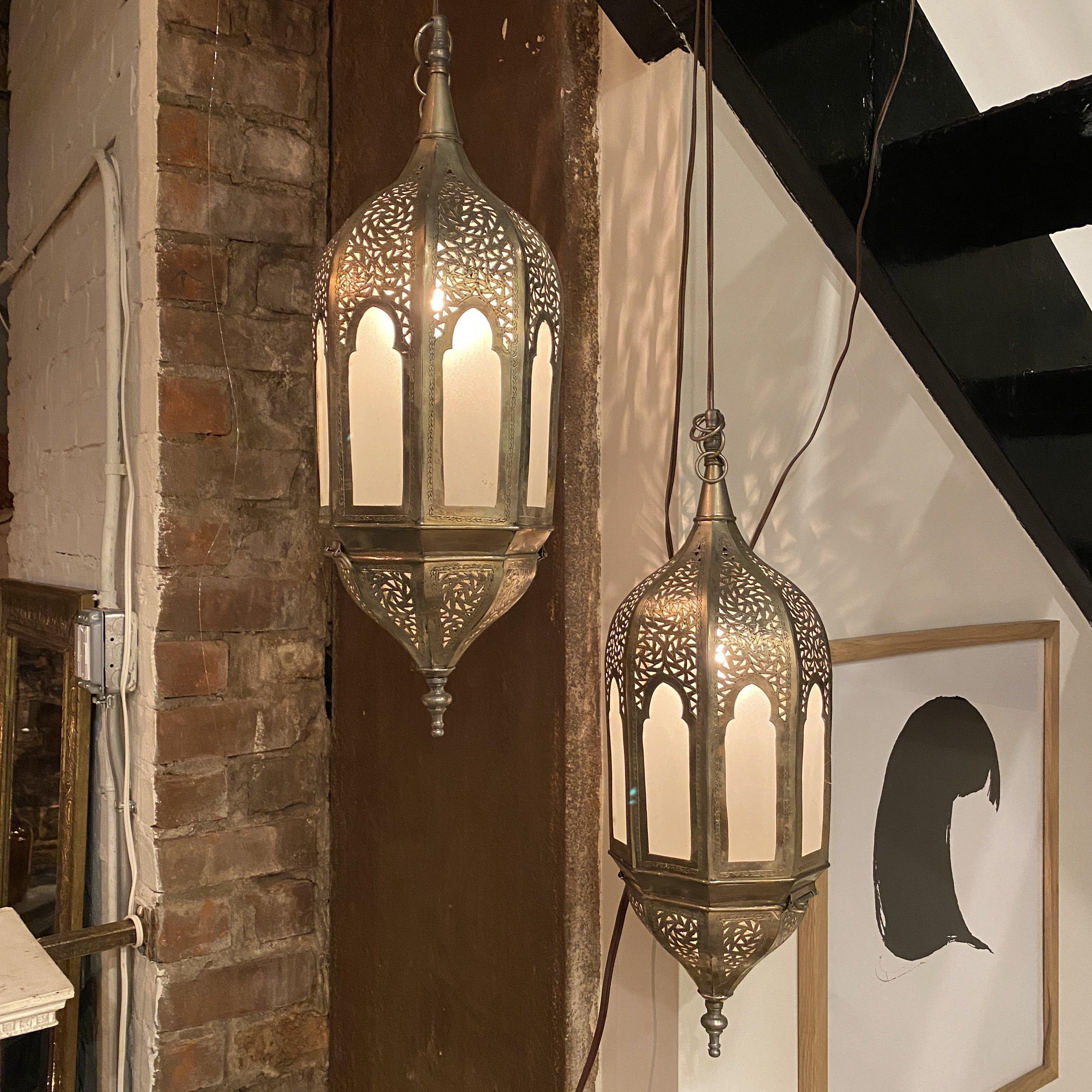 Exquisite frosted glass lantern with beautiful intricate brass design throughout. Perfect for an indoor/outdoor use. Adds stylish warmth to any space.