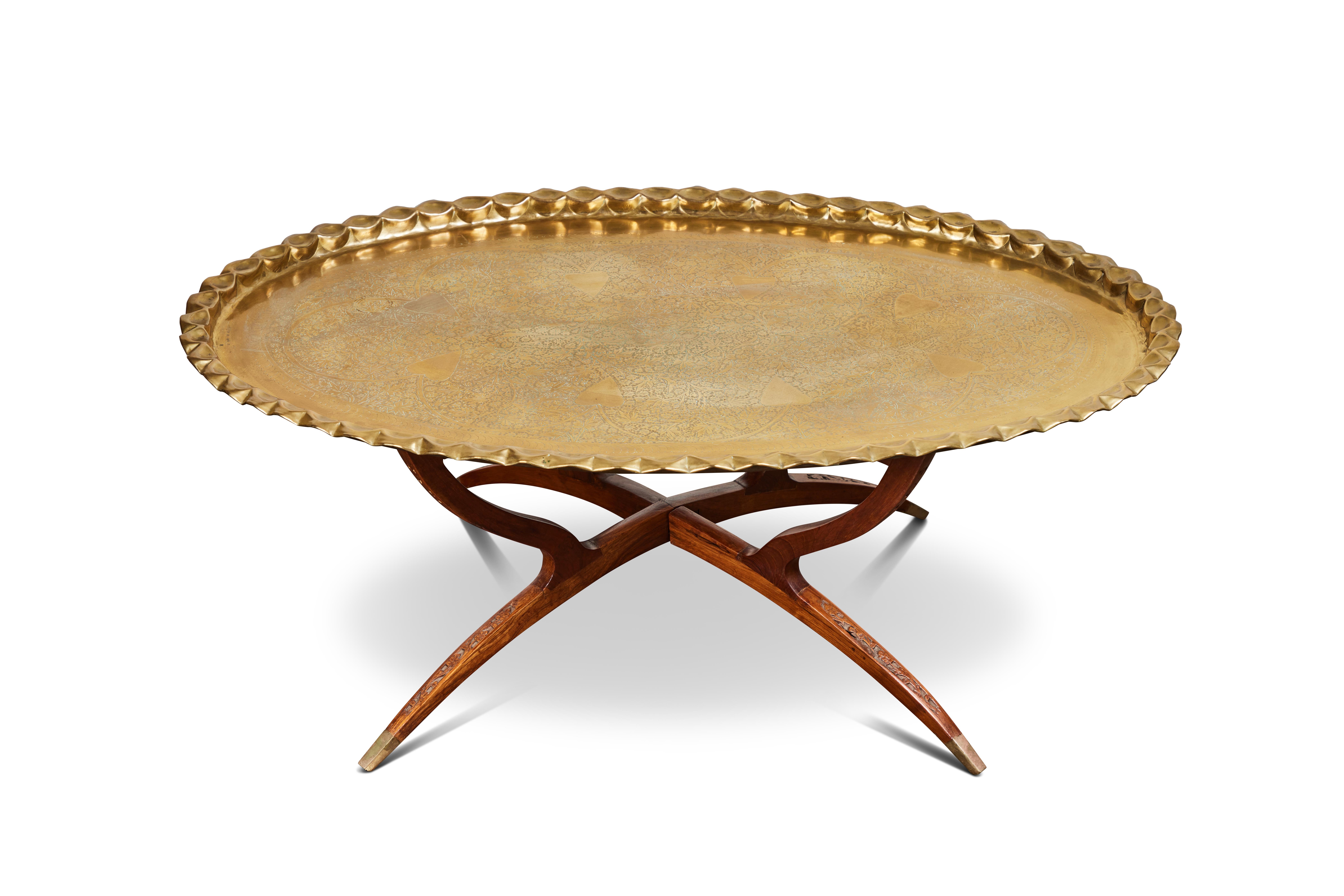 Boho chic Moroccan brass coffee table on a mid-century style wood table base.