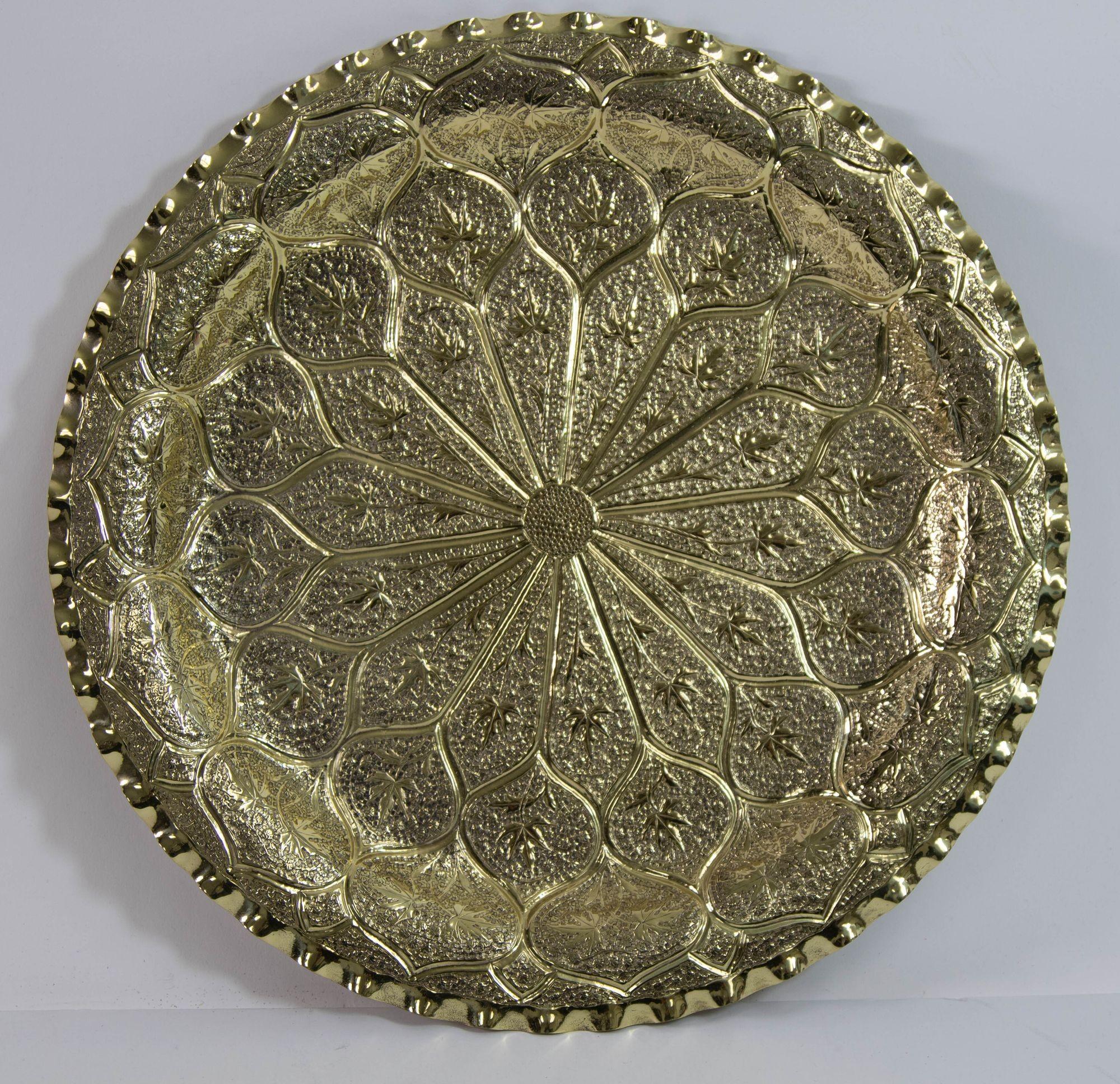 Antique 1940s Moroccan Brass Tray Hand Hammered with Moorish design, Islamic Metalwork.
Dimension: 13 inches Diameter.
This antique 1940s Moroccan polished brass tray is a collectible Islamic Metalwork Platter.
The Islamic polished brass metalwork,