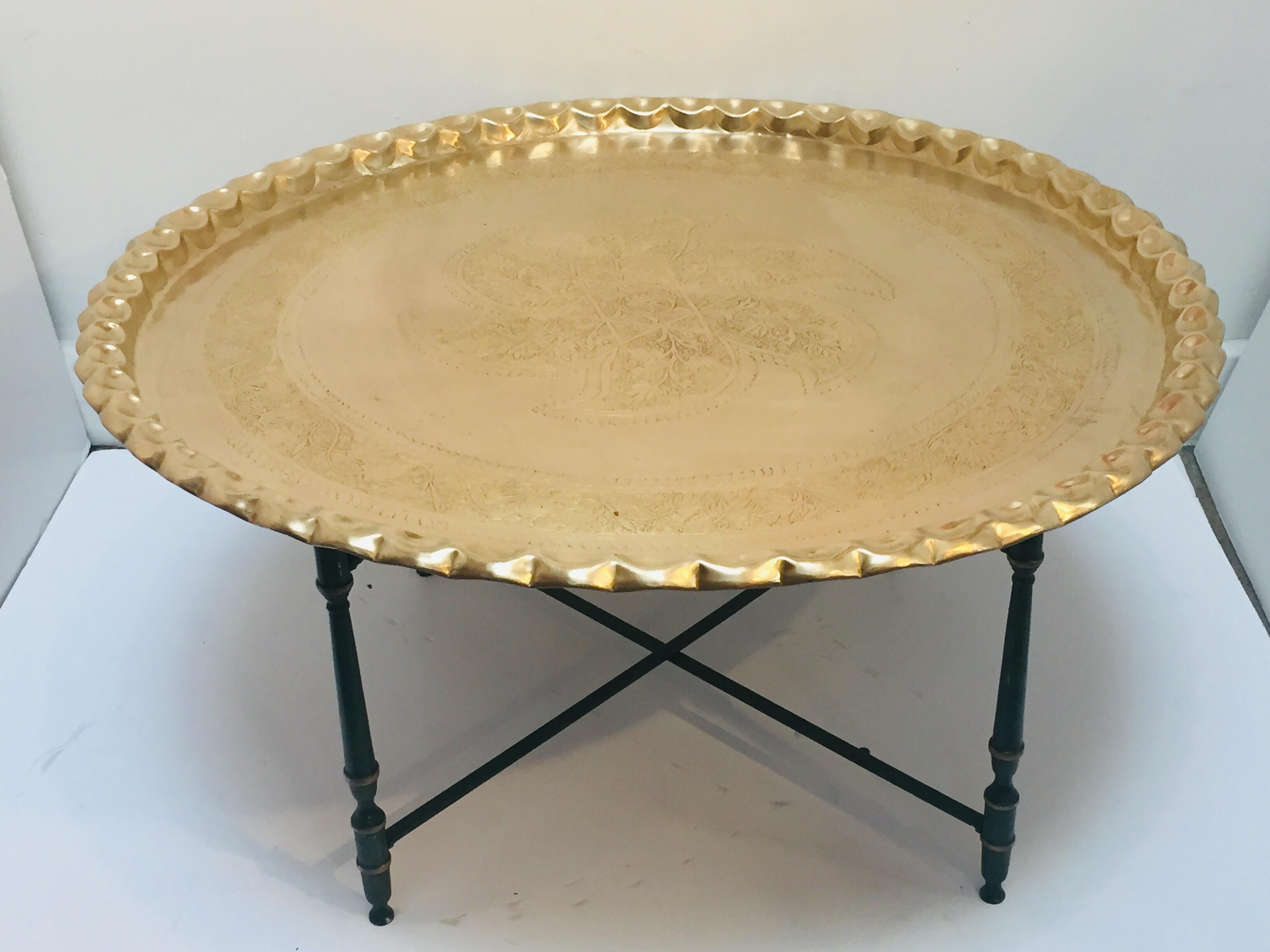 Large round Moroccan brass tray table 40 inches.
Polished brass tray, very good condition, standing on metal folding brass finals.
Very hard to find Mid-Century Modern polished brass tray table.
This large Moorish style hand-hammered brass tray