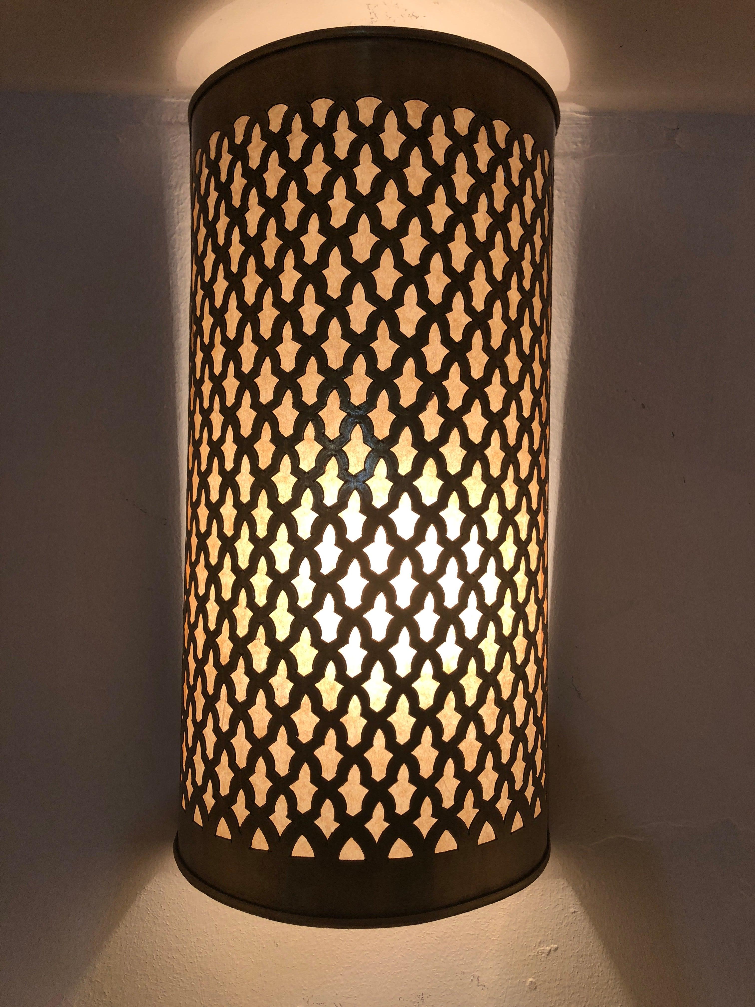 The wall lantern features an exquisite filigree work with exotic design motif. The handcrafted gold brass wall lantern emit soft filtered light and will elevate the ambiance of any room. 
The sconce is not wired. It comes as a shell and can be