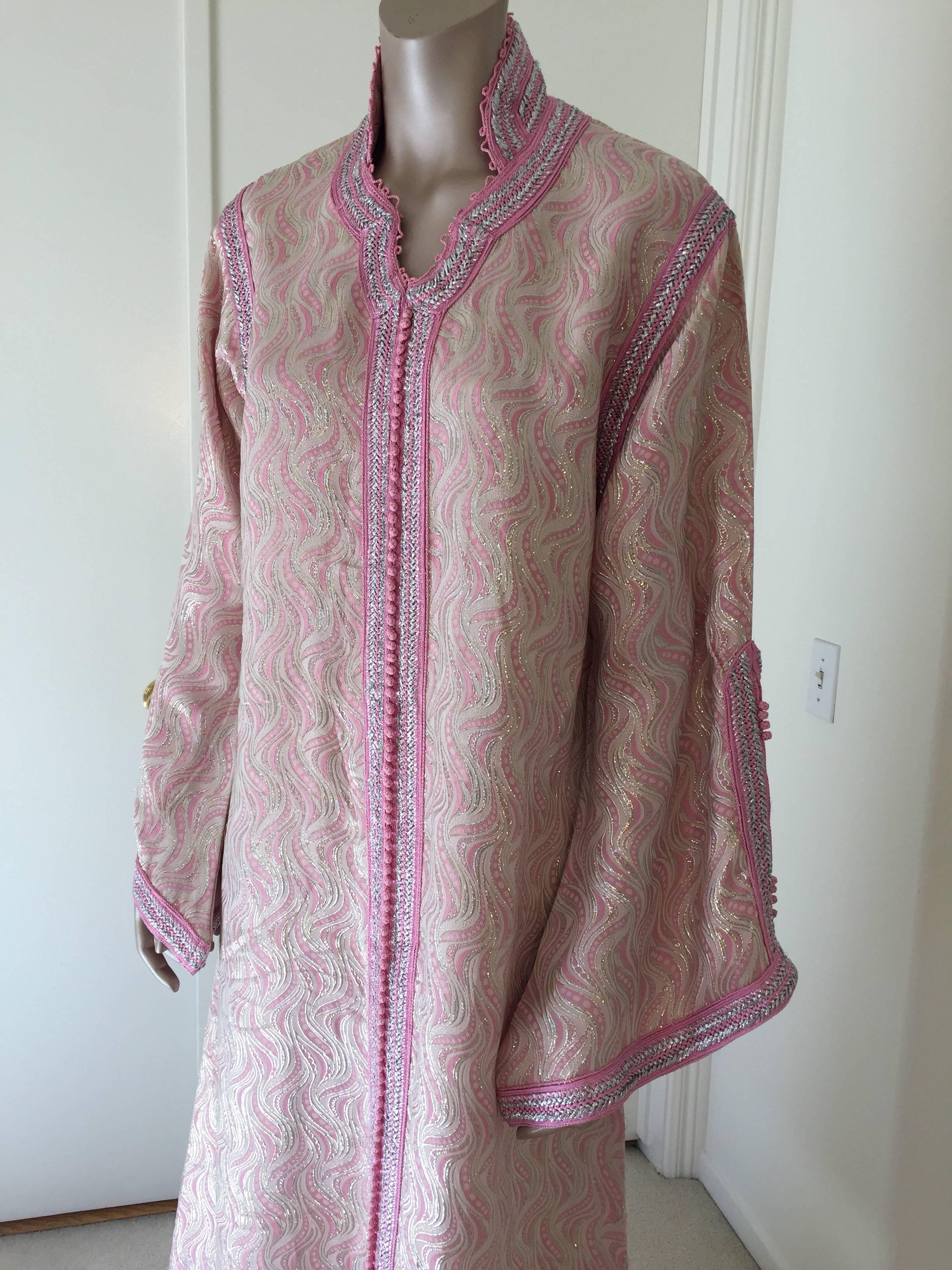 Elegant vintage designer Moroccan caftan, embroidered with pink and silver trim.
This chic Gypsy Bohemian maxi dress kaftan is embroidered and embellished with silver thread metallic trim.
One of a kind, made to measure evening Moroccan Middle