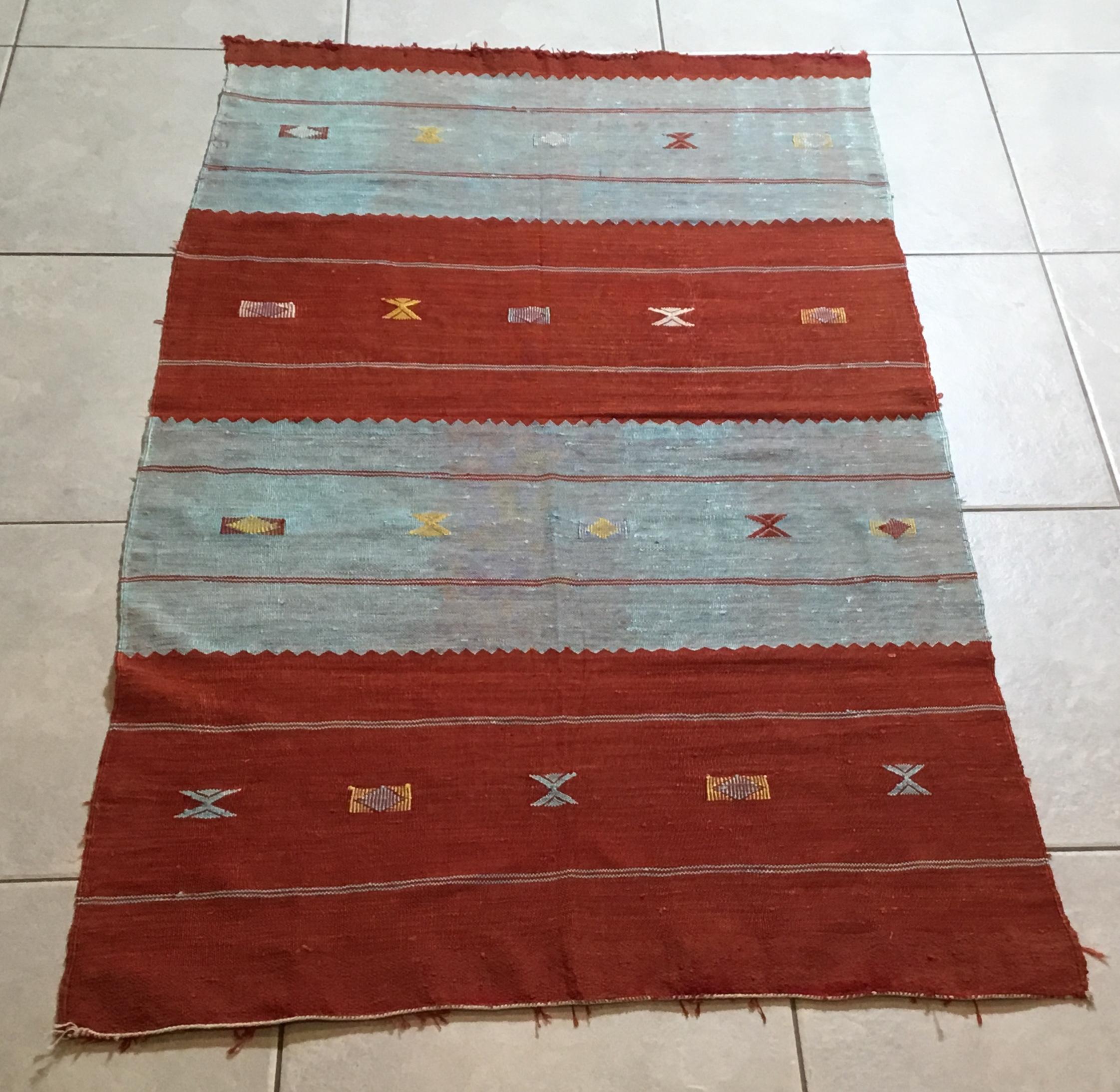 Beautiful decorative handwoven rug with soft multicolor geometric motifs on a red-turquoise color background. nicely feel to touch .
Could be used as a wall hanging tapestry.