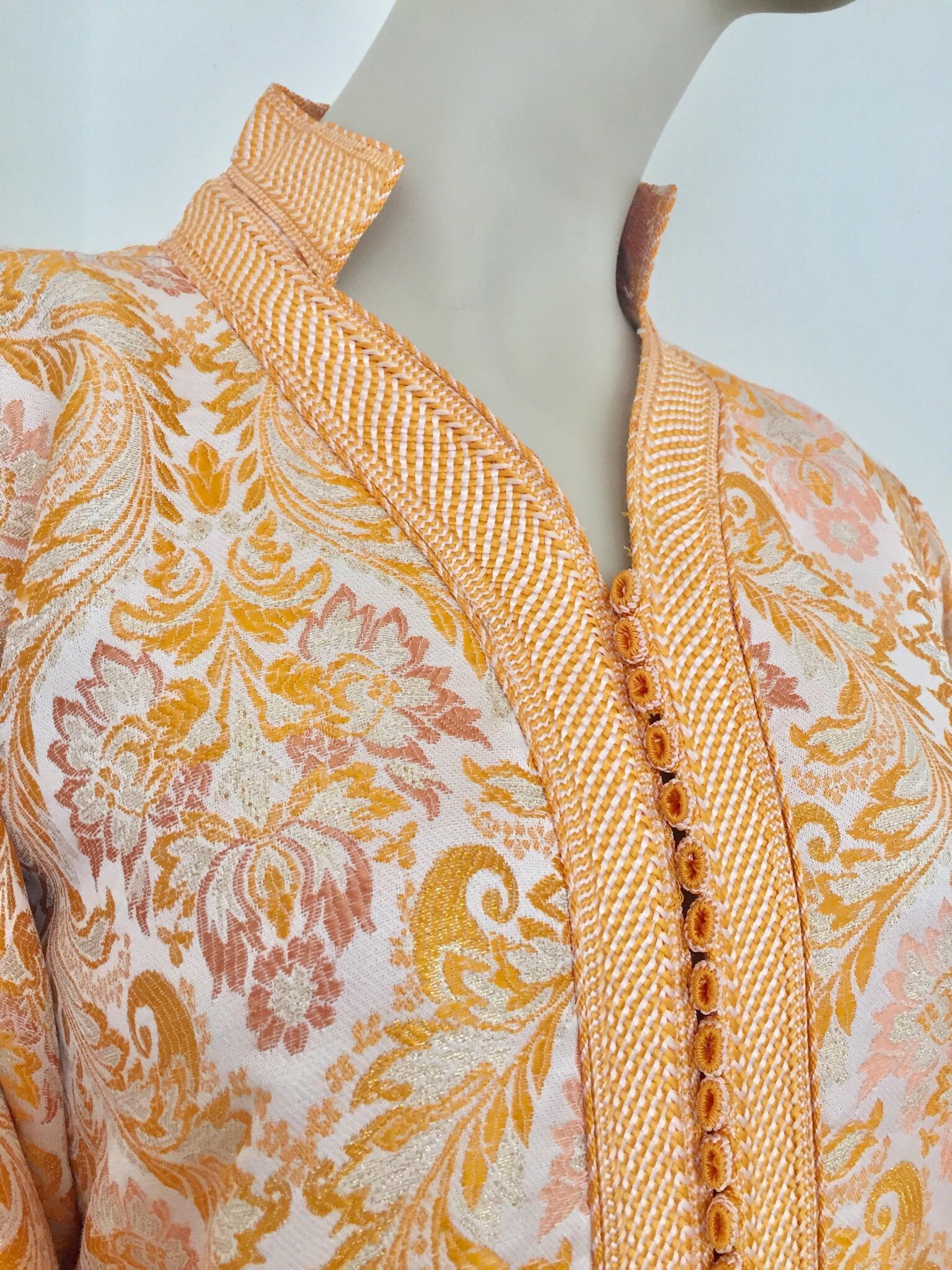 Moroccan caftan in gold damask brocade maxi dress kaftan handmade by Moroccan Artist.
Handcrafted vintage exotic 1970s gold and orange brocade ceremonial caftan gown from North Africa, Morocco.
The luminous brocade fabric shimmers with all-over