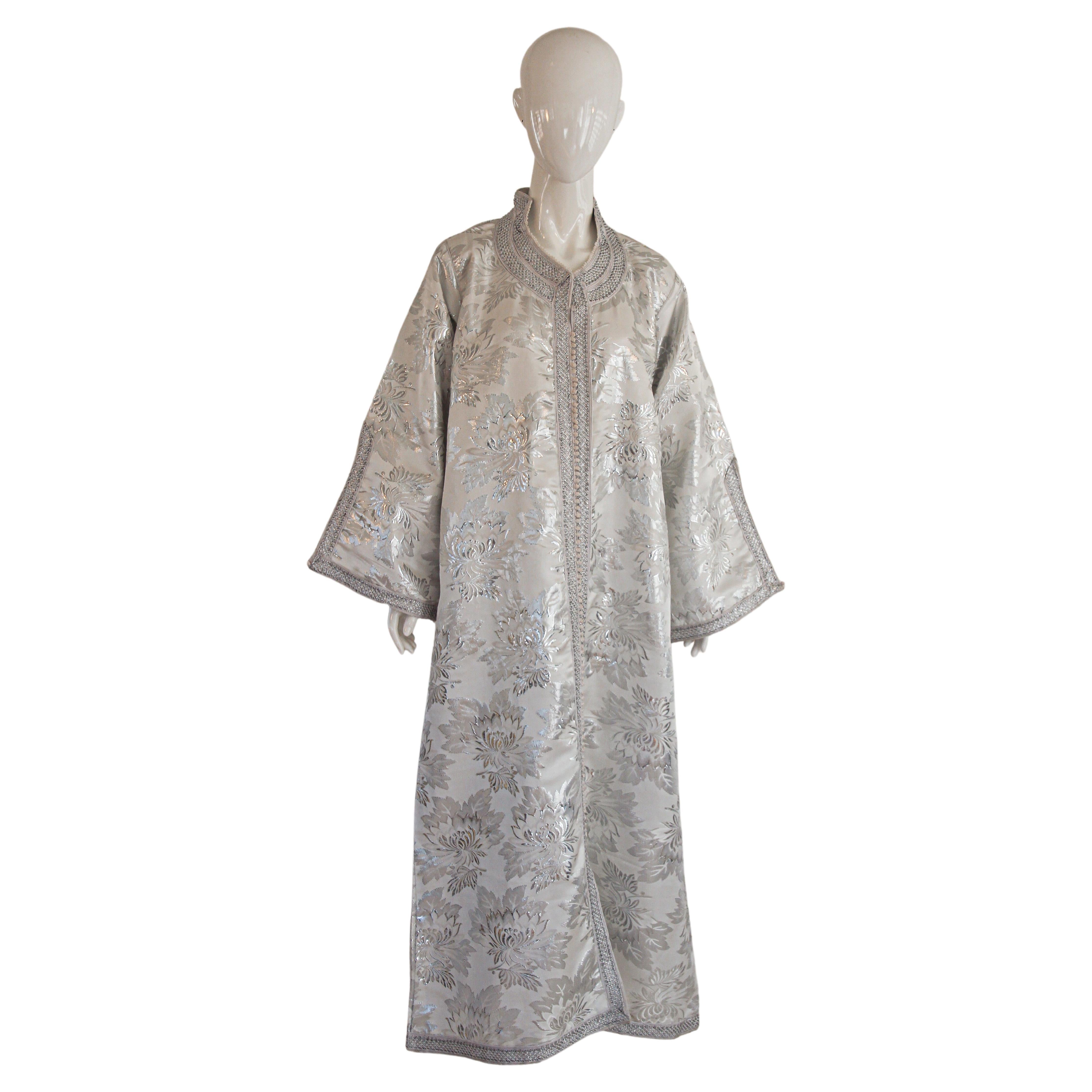 Amazing vintage Moroccan Caftan, silver silk damask with silver threads trim, Circa 1960's
The light silver damask kaftan was entirely finish by hand.
One of a kind evening antique Moorish gown.
This authentic caftan has been hand-sewn from high end