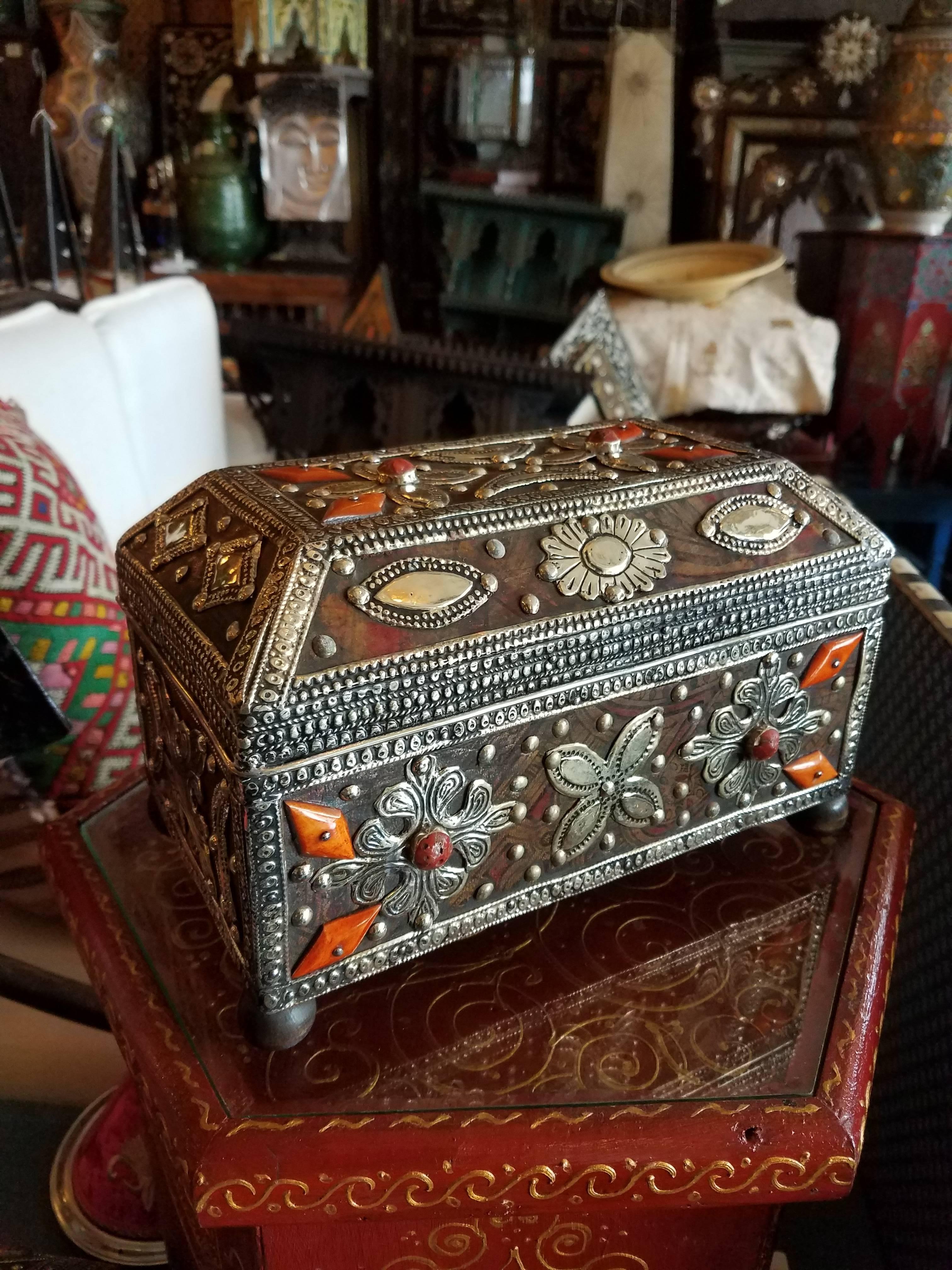 A beautiful Moroccan camel bone trunk from Marrakech. Camel bone dyed in Henna and colorful leather patches mixed with metal inlaid makes this trunk a great addition to any décor. Measuring approximately 9.5