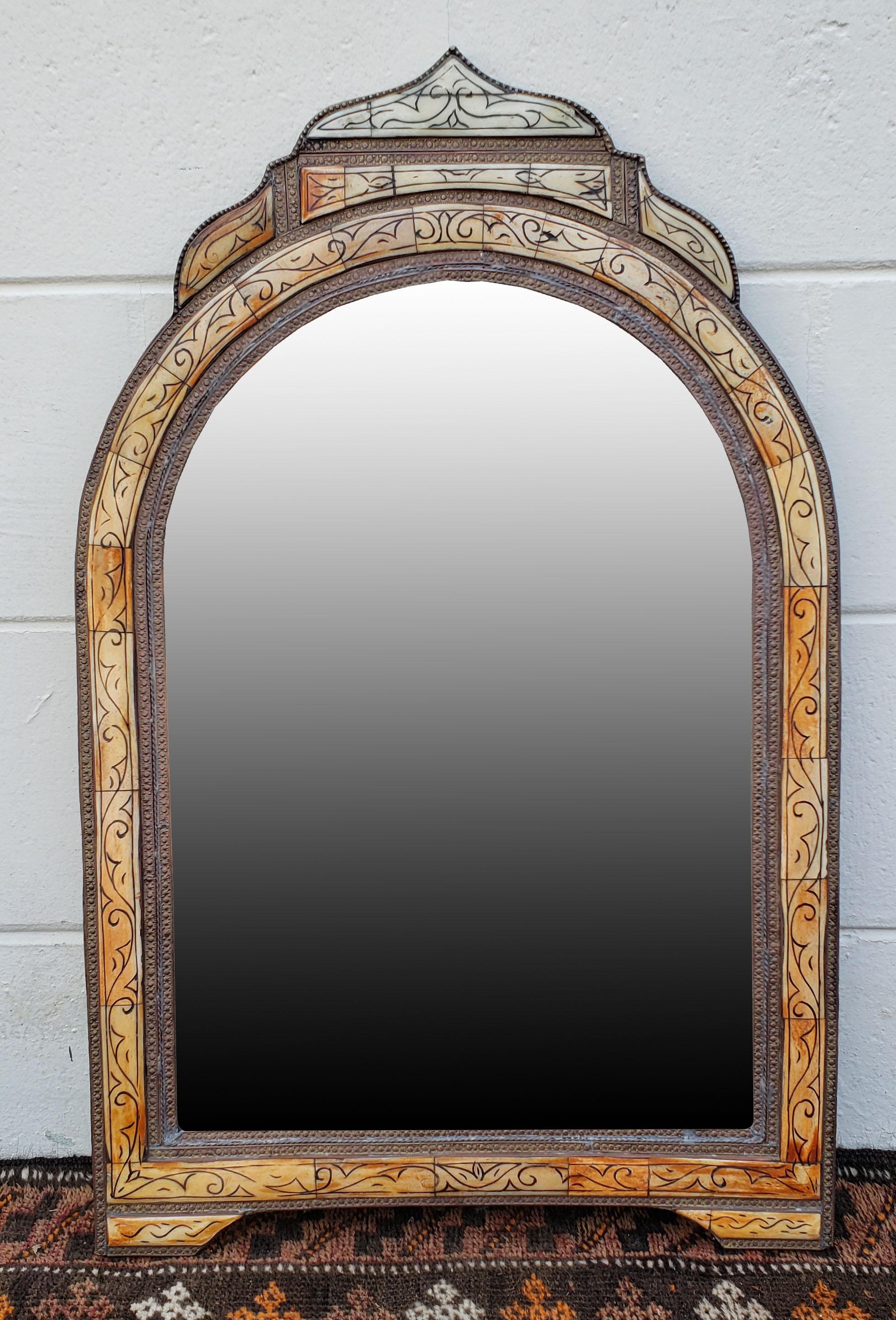 Small size metal and camel bone inlay Moroccan mirror. Made in the city of Marrakech. Rectangular shape with an arched top, and measuring approximately 28