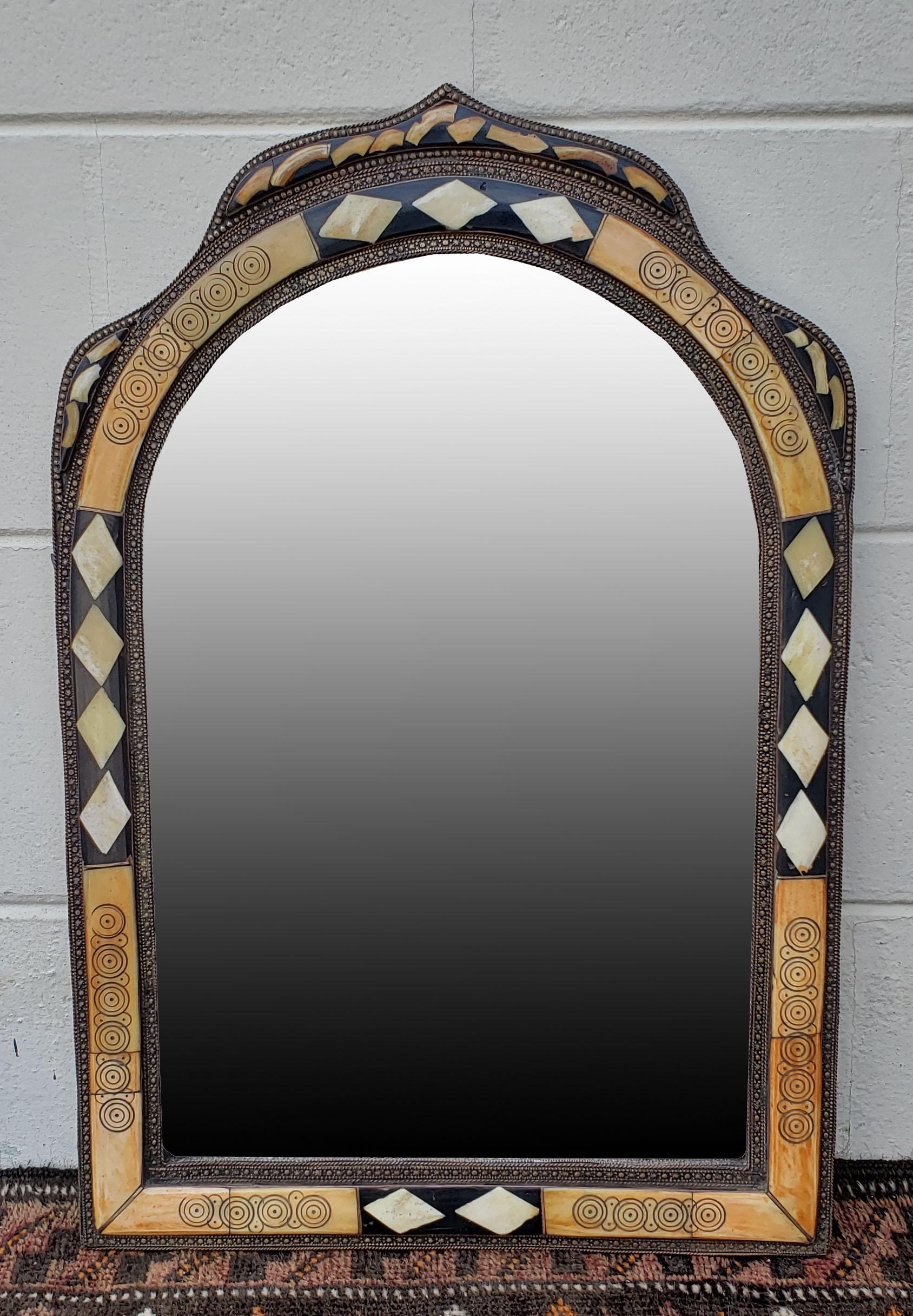 Small size metal and camel bone inlay Moroccan mirror. Made in the city of Marrakech. Rectangular shape with an arched top, and measuring approximately 23