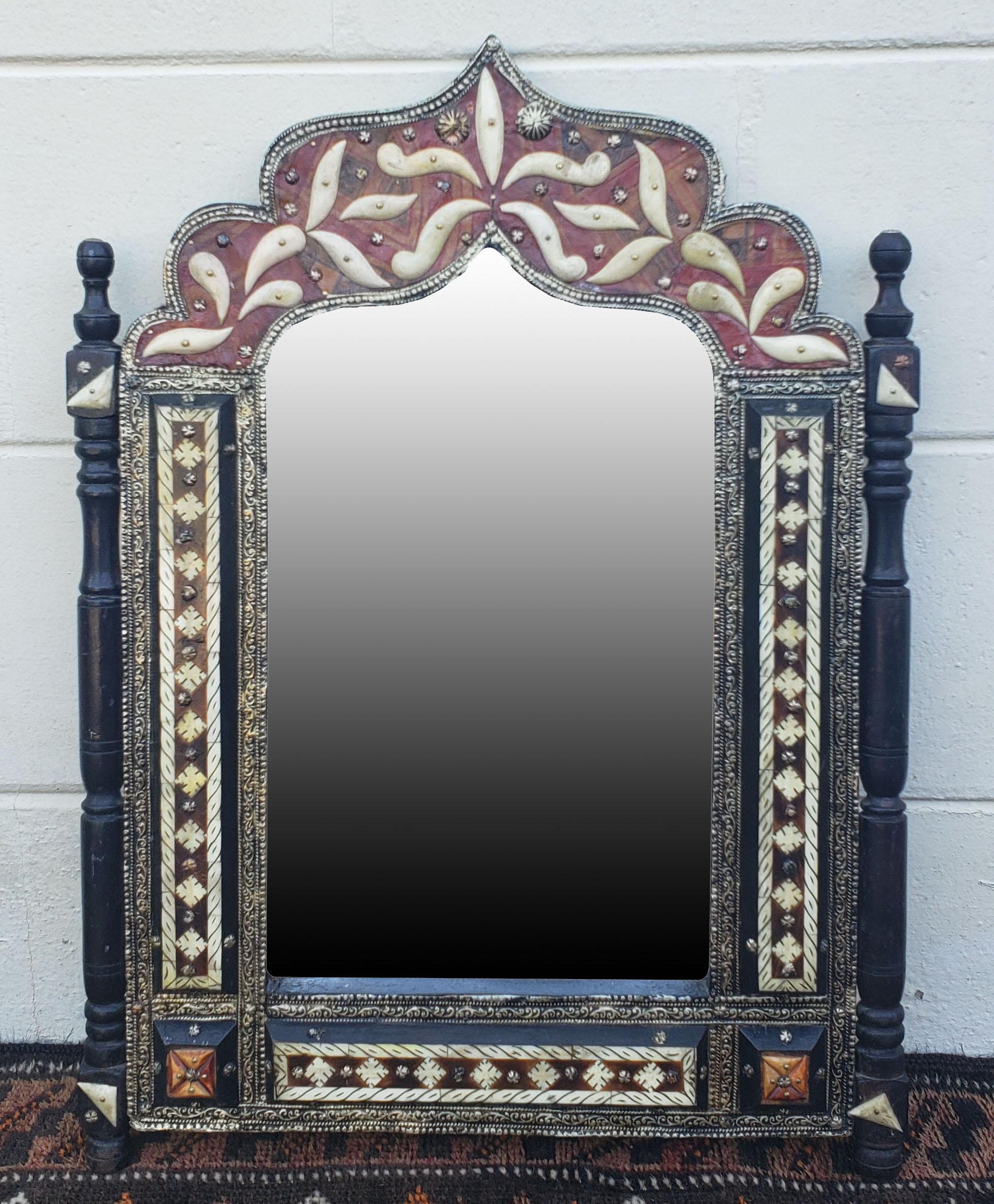 Small size metal and camel bone inlay Moroccan mirror. Made in the city of Marrakech. Rectangular shape with an arched top, and measuring approximately 23.5