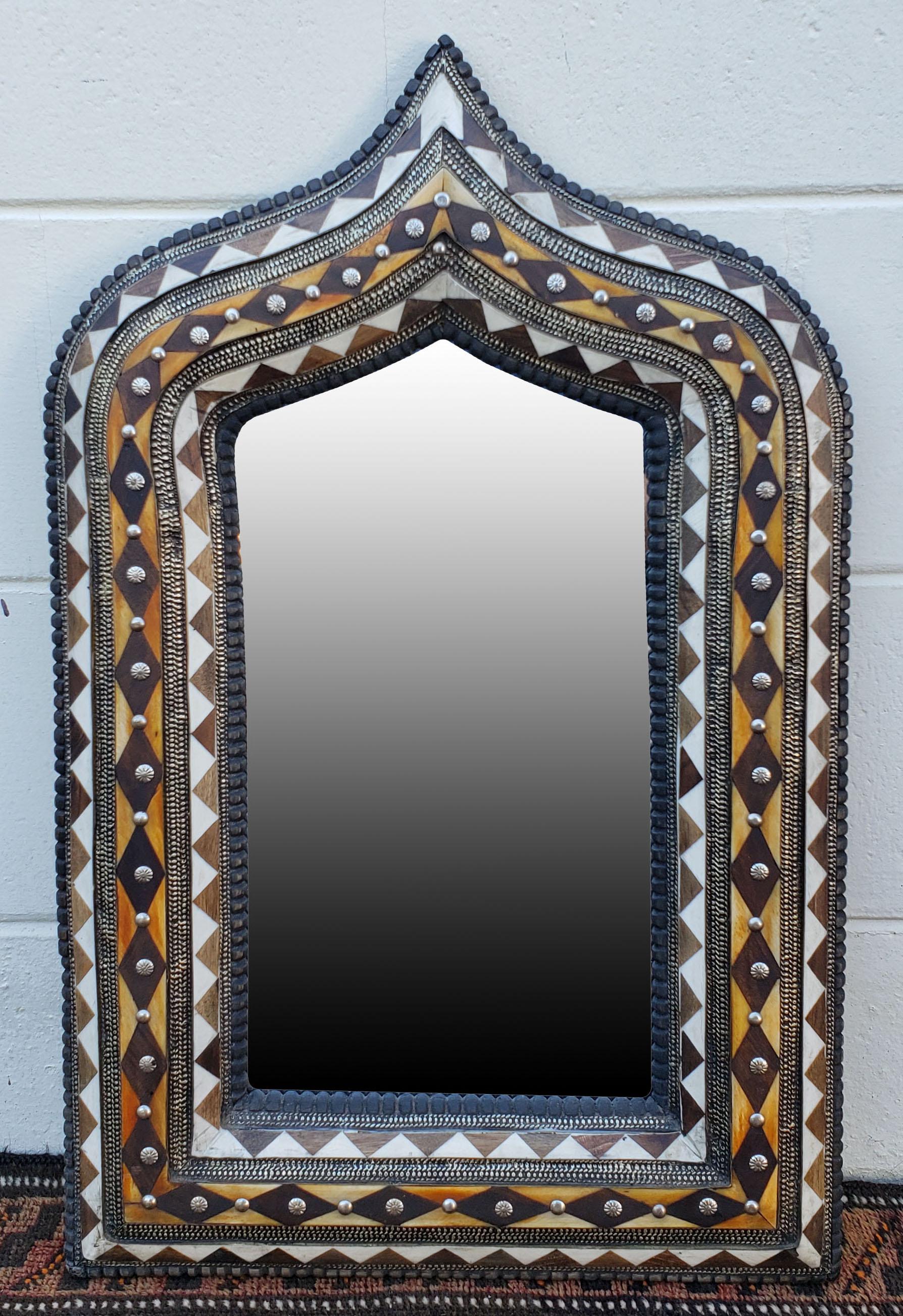 Small size metal and camel bone inlay Moroccan mirror. Made in the city of Marrakech. Rectangular shape with an arched top, and measuring approximately 23.5