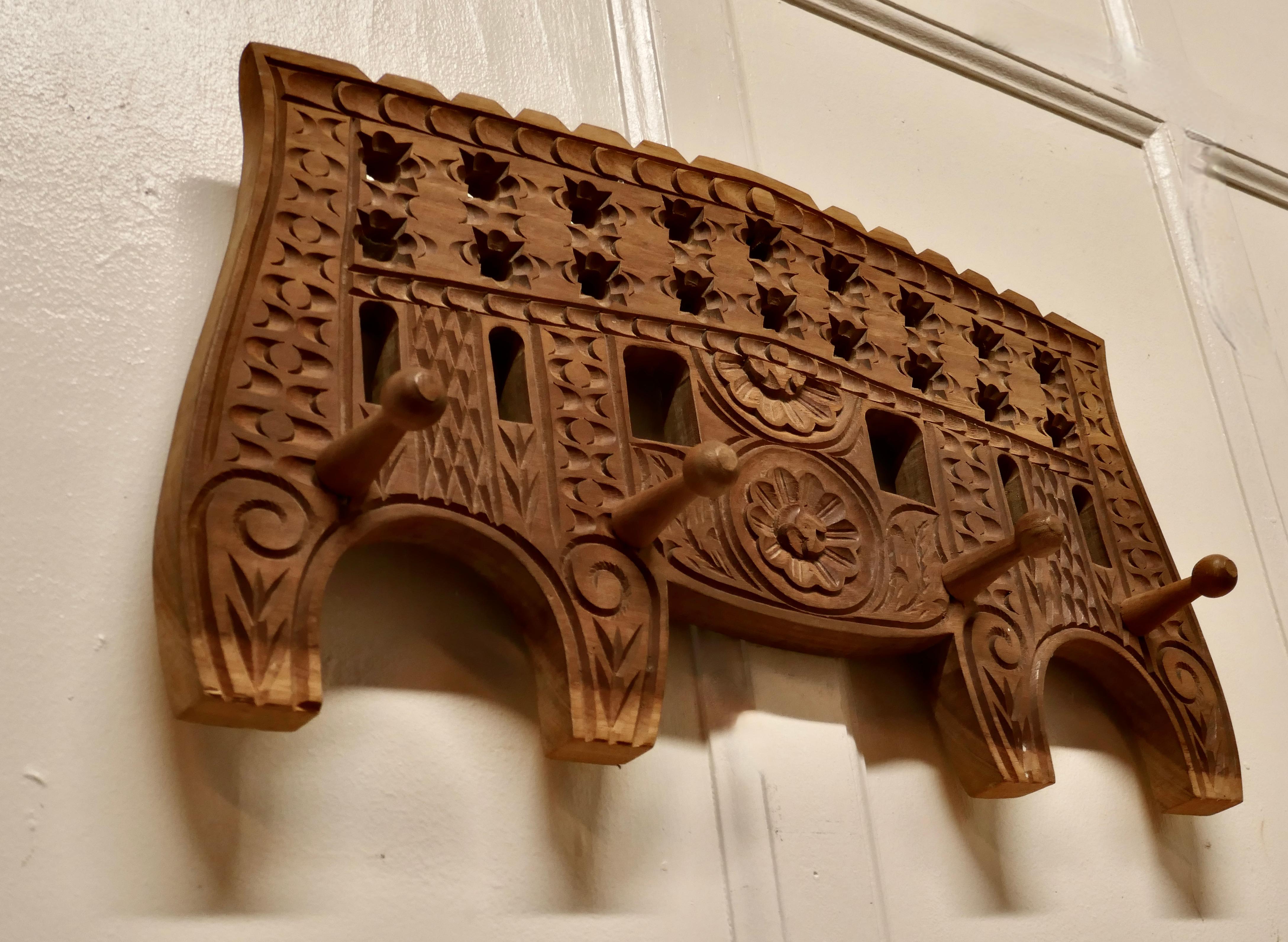 Moroccan carved fruitwood coat/hat hooks

Carved hard wood coat hooks, for coats umbrellas or hats

This is a sturdy piece, it is carved in the typically Moroccan Style, and it has 4 turned coat hooks
The Rack is 13” high, 22” long and is about