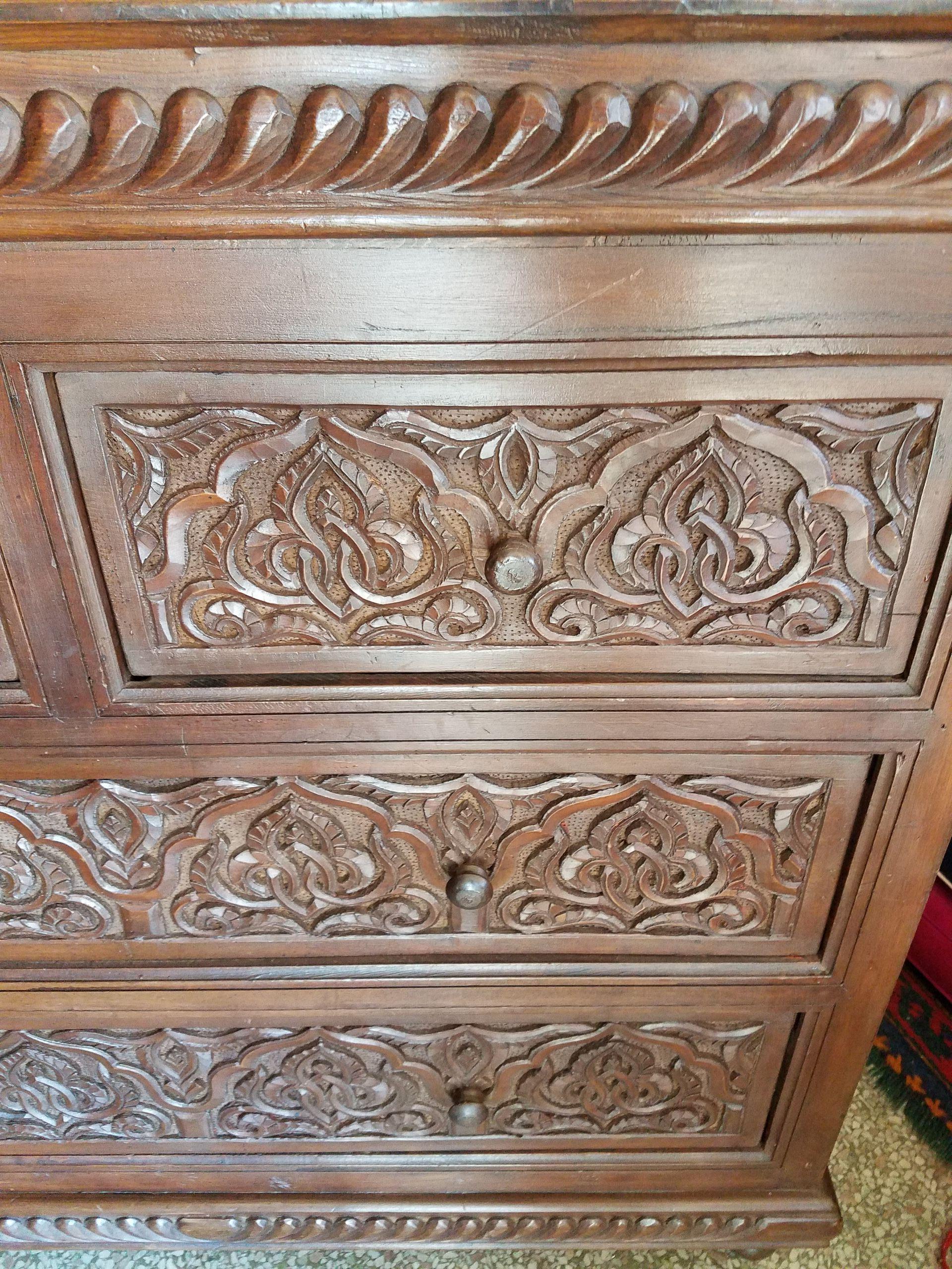 Handmade in Rabat, Morocco. Beautiful chocolate brown cedar wooden cabinet measuring 33” in height, 36” in width, and 16” in depth, and featuring two large and 2 small drawers. Plenty of storage. Lots of carvings throughout. amazing design and