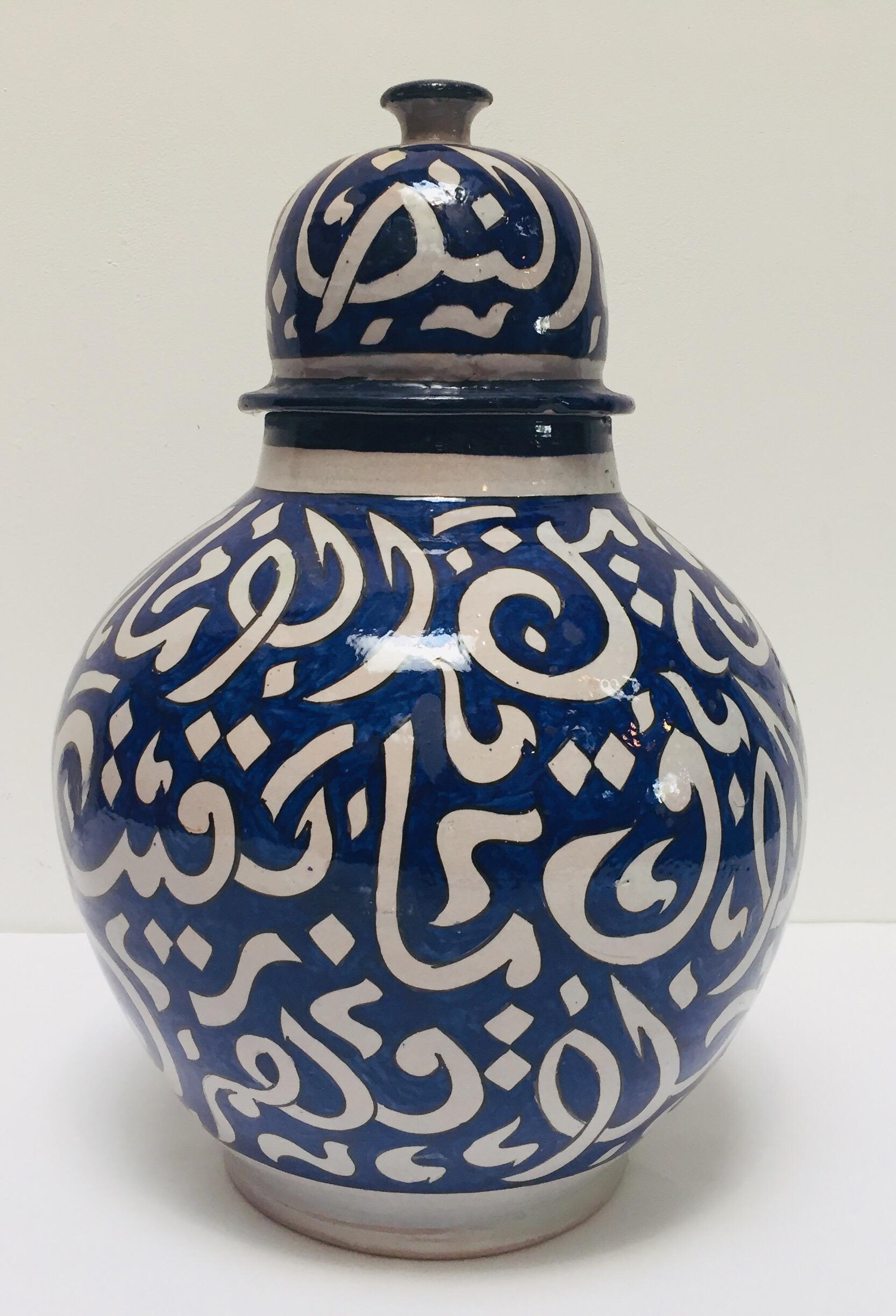 Large Moroccan glazed ceramic urn with lid from Fez.
Moorish style ceramic handcrafted and hand painted with Arabic calligraphy writing.
This kind of art writing looks calligraphic is called Lettrism, it is a form of art that uses letters that are