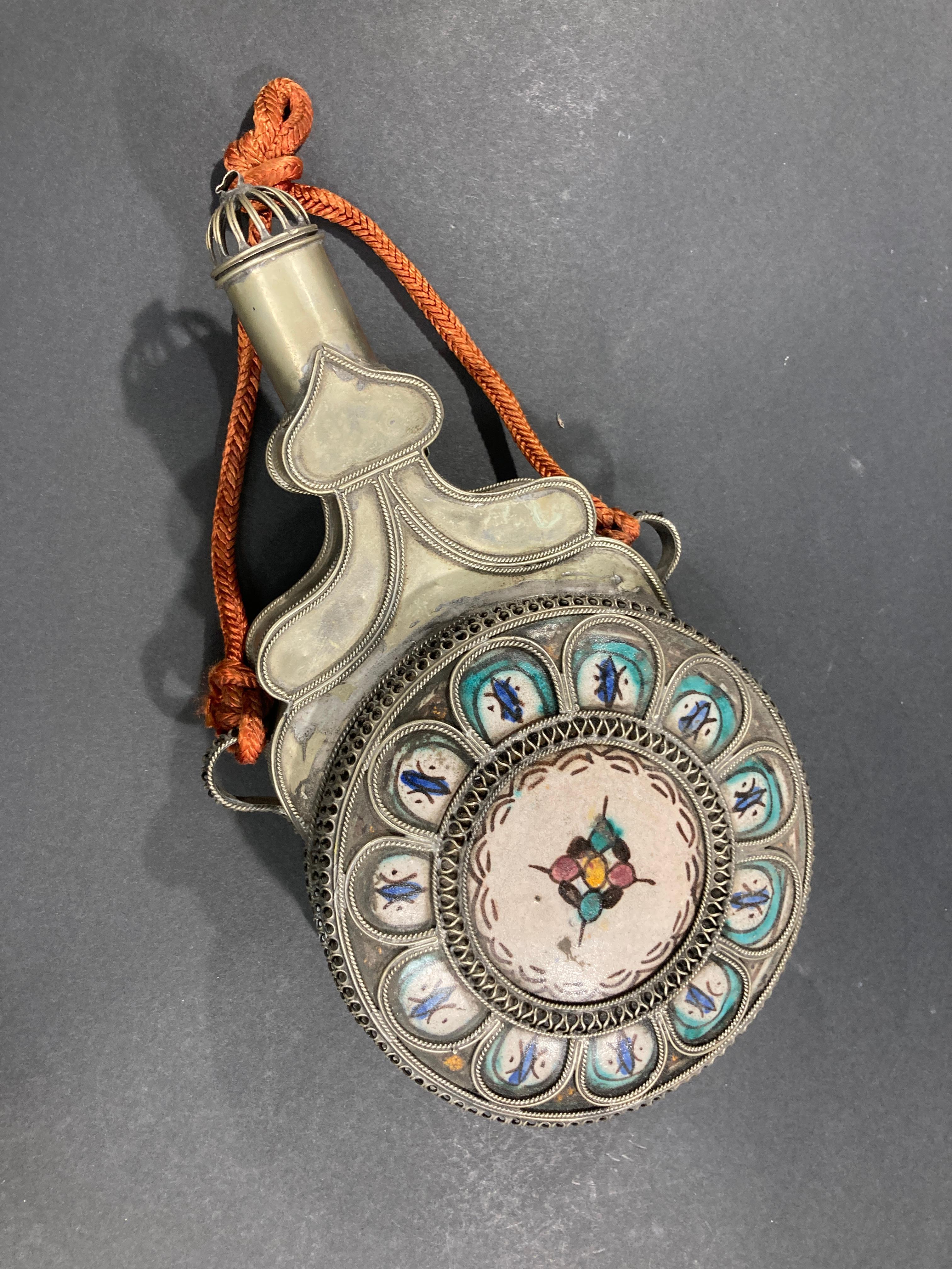 Early 20th century antique Moroccan ceramic from Fez, adorned with silver nickel filigree handwork.
Great one of a kind handcrafted urn with lid with hand-painted designs.
Great Moorish accent.
Moroccan earthenware from Fez with the