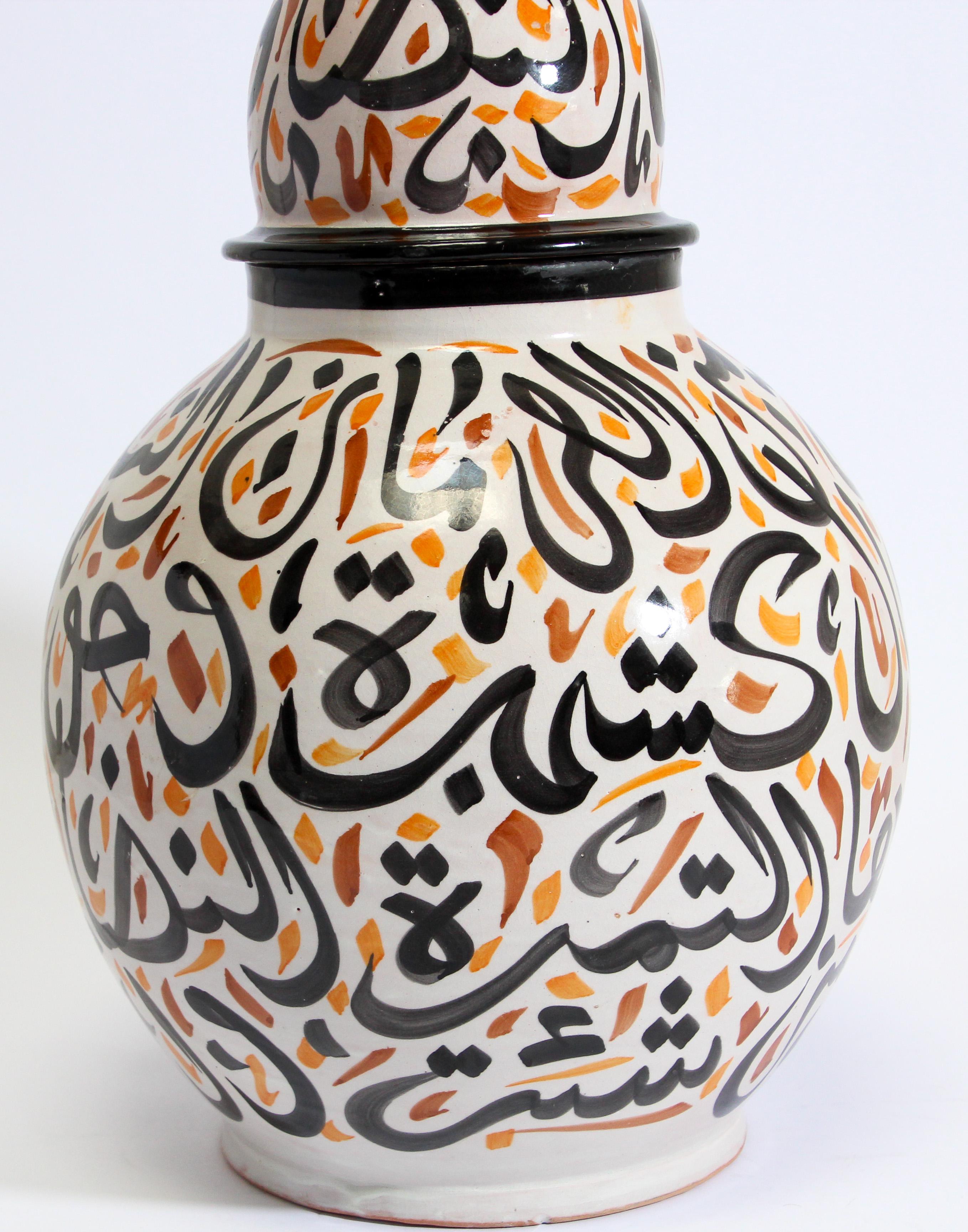 Large Moroccan glazed ceramic urn with lid from Fez.
Moorish style ceramic handcrafted and hand painted with Arabic calligraphy writing.
This kind of Art Writing looks calligraphic is called Lettrism, it is a form of art that uses letters that are