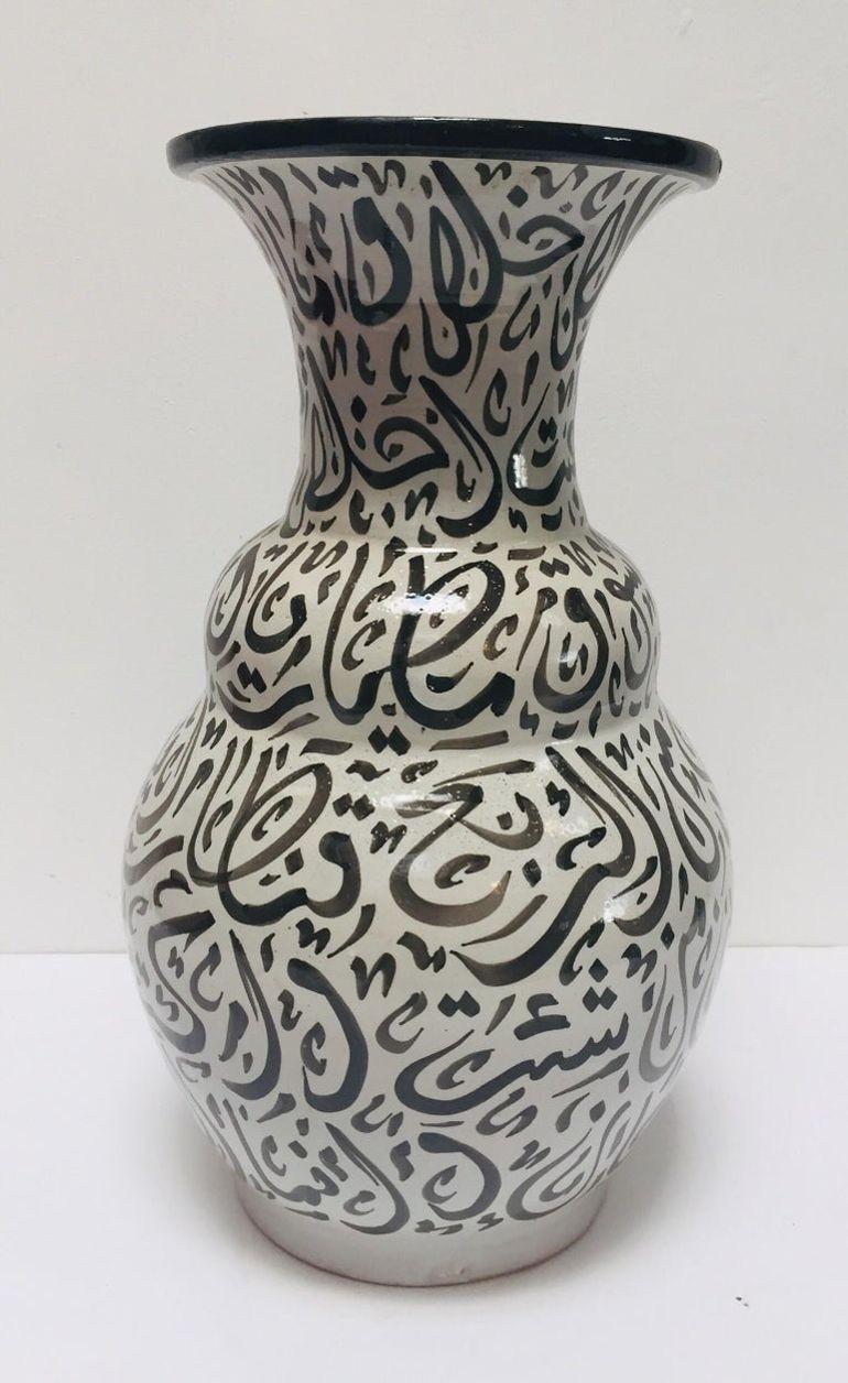 Large Moroccan glazed ceramic vase from Fez.
Moorish Granada style ceramic handcrafted and hand painted with Arabic calligraphy writing.
This kind of art writing looks calligraphic is called Lettrism, it is a form of art that uses letters that are