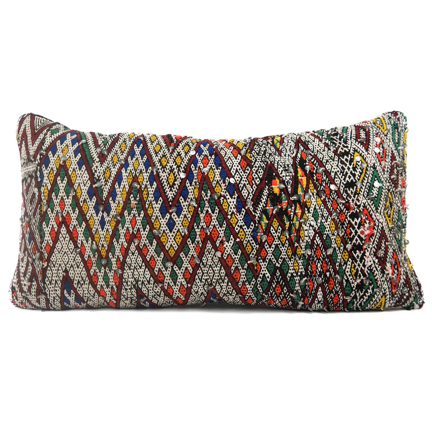 A stunning extra large bohemian Moroccan kilim cushion custom made in Morocco. Cut from a circa 40 years old hand loomed kilim rug, from the Middle Atlas Mountains. We have searched and selected the rug ourselves. The pillow has beautiful colors