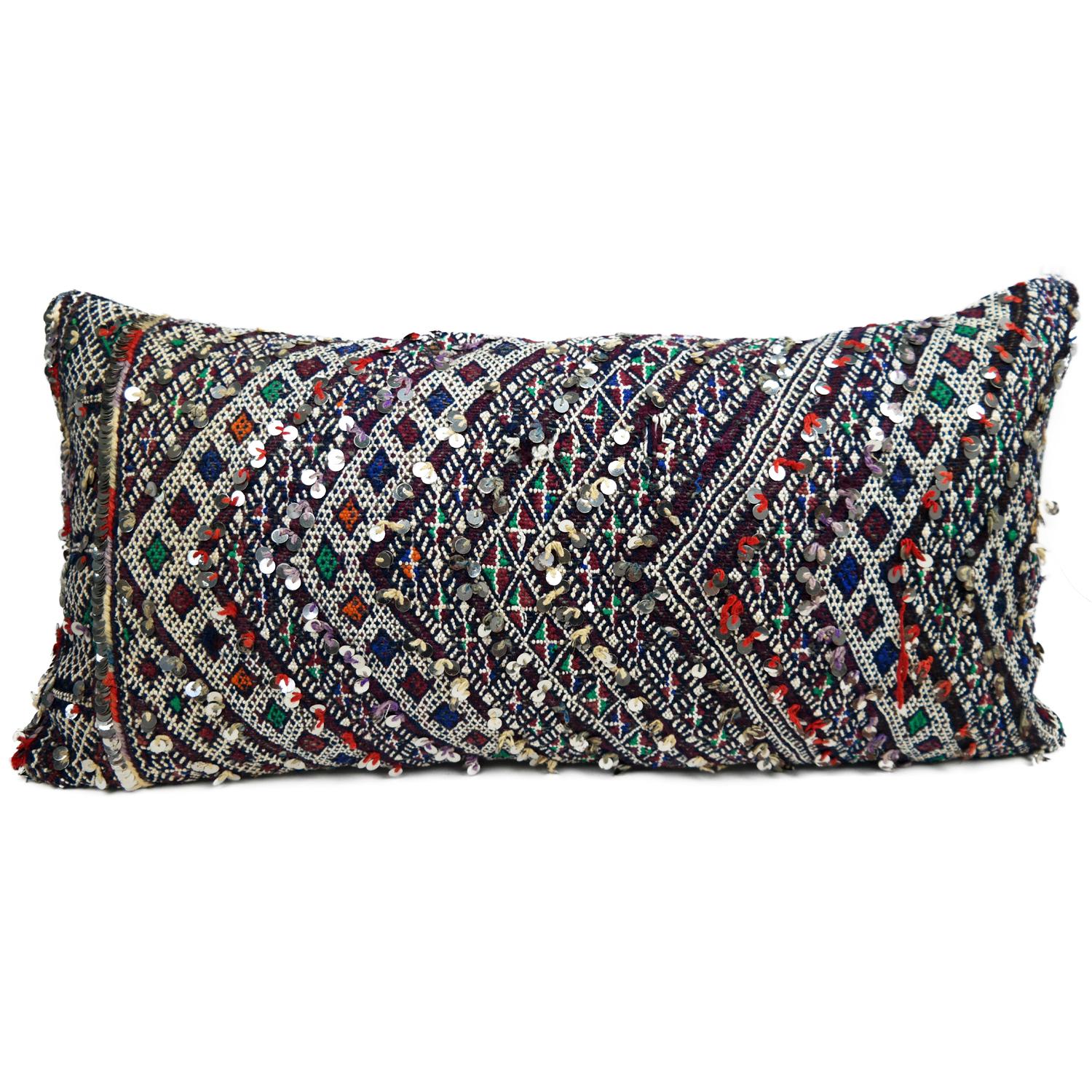 A stunning XL bohemian Moroccan kilim cushion custom made in Morocco.  Cut from a circa 40 years old hand loomed kilim rug, from the Middle Atlas Mountains. We have searched and selected the rug ourselves. The pillow has beautiful exotic colors like